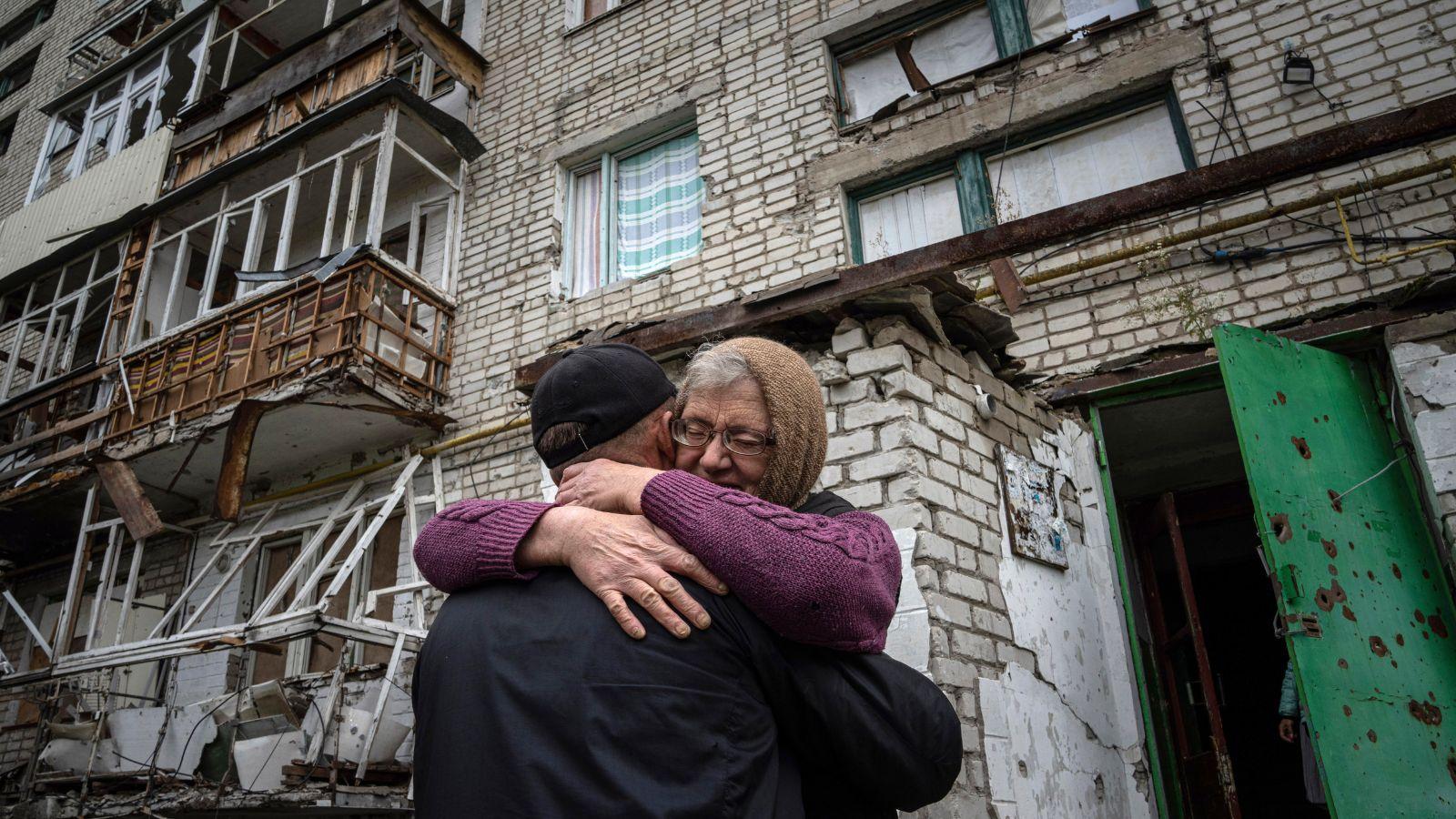 Yevdokia, 65, hugs her son Alexander in front of their house, which was heavily damaged by Russia attack, in the retaken area of Izium, Ukraine, on Sept. 14, 2022.