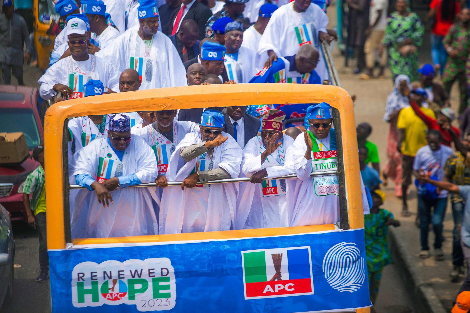 Bola Ahmed Tinubu, foreground right, presidential candidate of the All Progressives Congress, Nigeria ruling party, rides on a double decker bus during an election campaign rally in Lagos, Nigeria, Tuesday, Feb 21, 2023. 