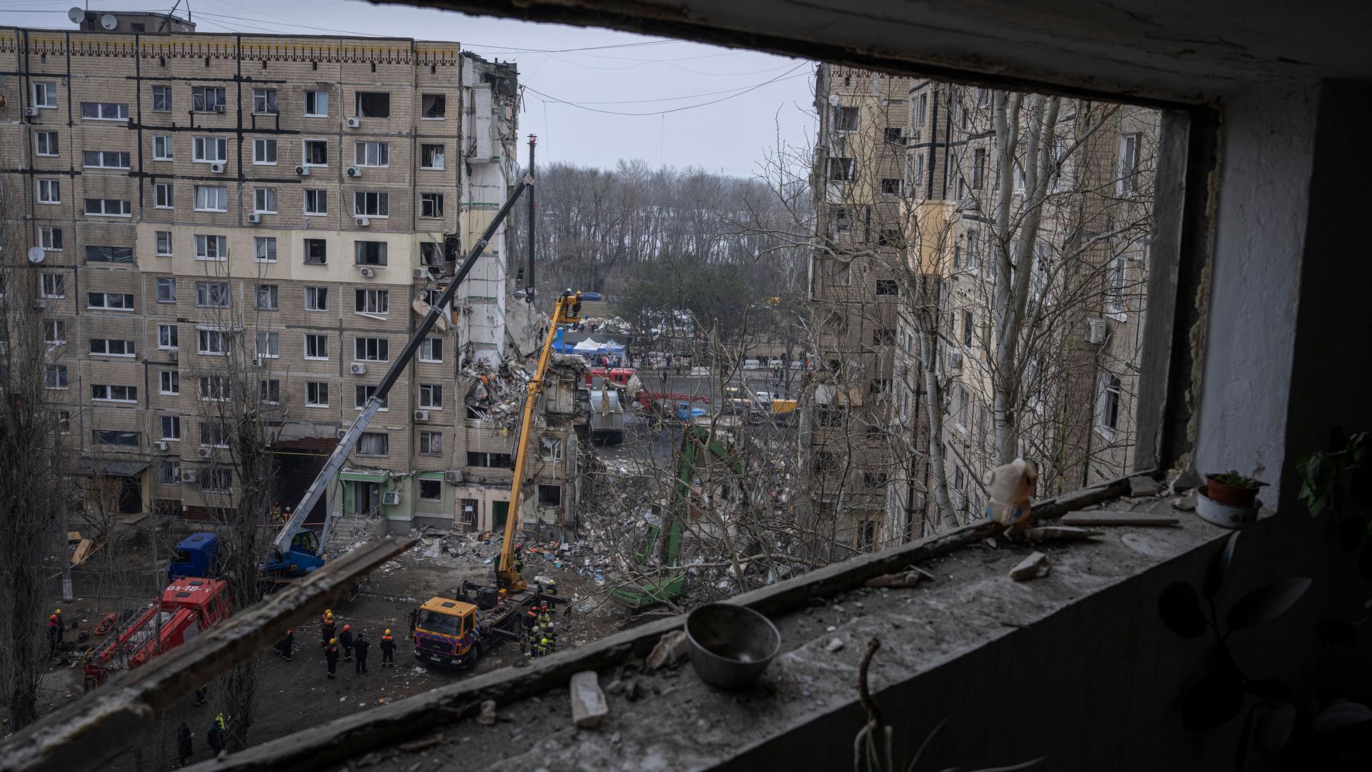 Rescue workers clear the rubble from an apartment building that was destroyed in a Russian rocket attack at a residential neighbourhood in the southeastern city of Dnipro, Ukraine, Monday, Jan. 16, 2023. 