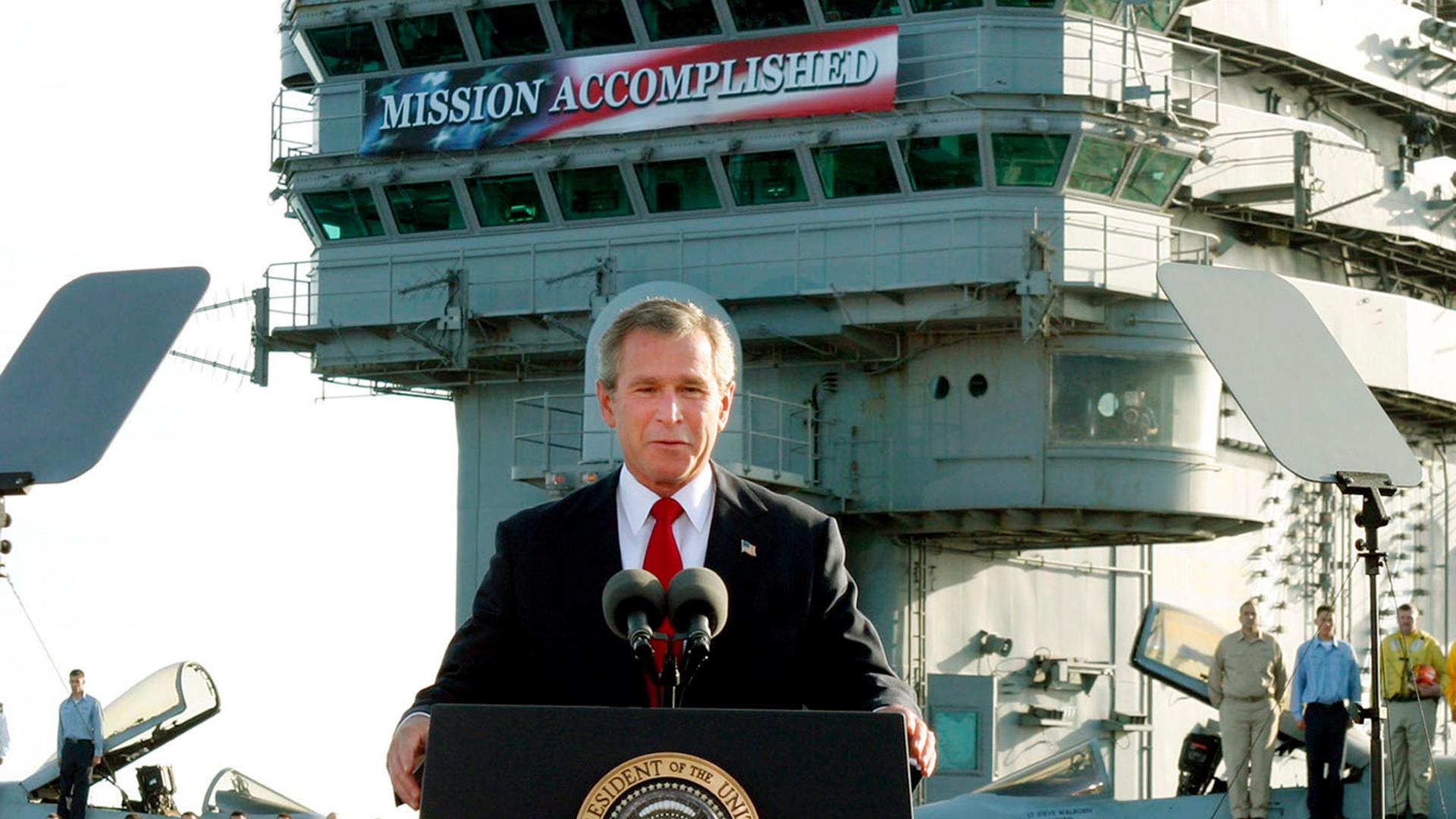 President George W. Bush declares the end of major combat in Iraq as he speaks aboard the aircraft carrier USS Abraham Lincoln off the California coast. But the war dragged on for many years after that.