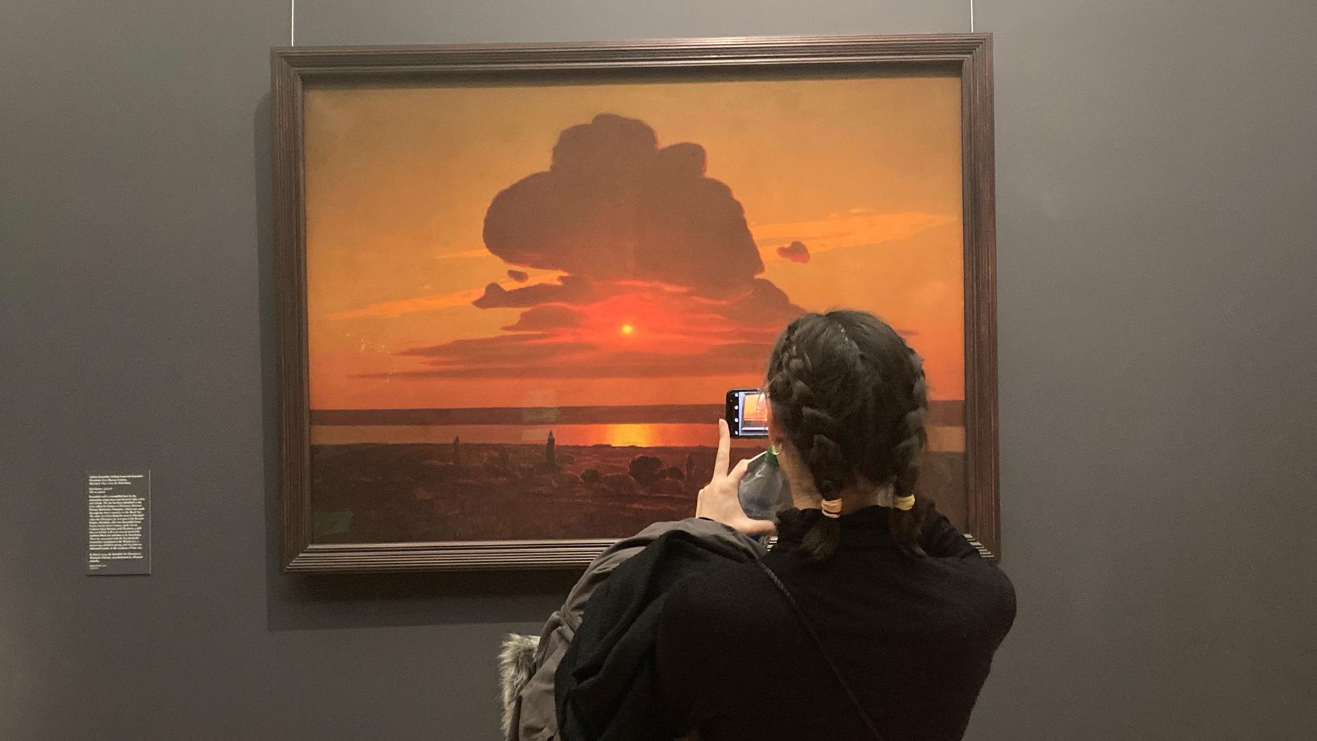 A visitor takes in the painting “Red Sunset," by Mariupol painter Arkhyp Kuindzhi. 