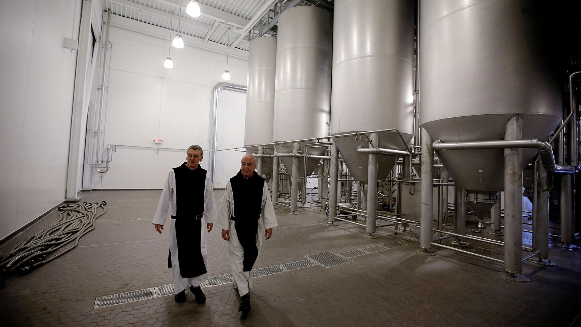 Father Damion, abbot at St. Joseph's Trappist Abbey, left, and Spencer Brewery director Father Isaac walk through their new, state-of-the-art facility.