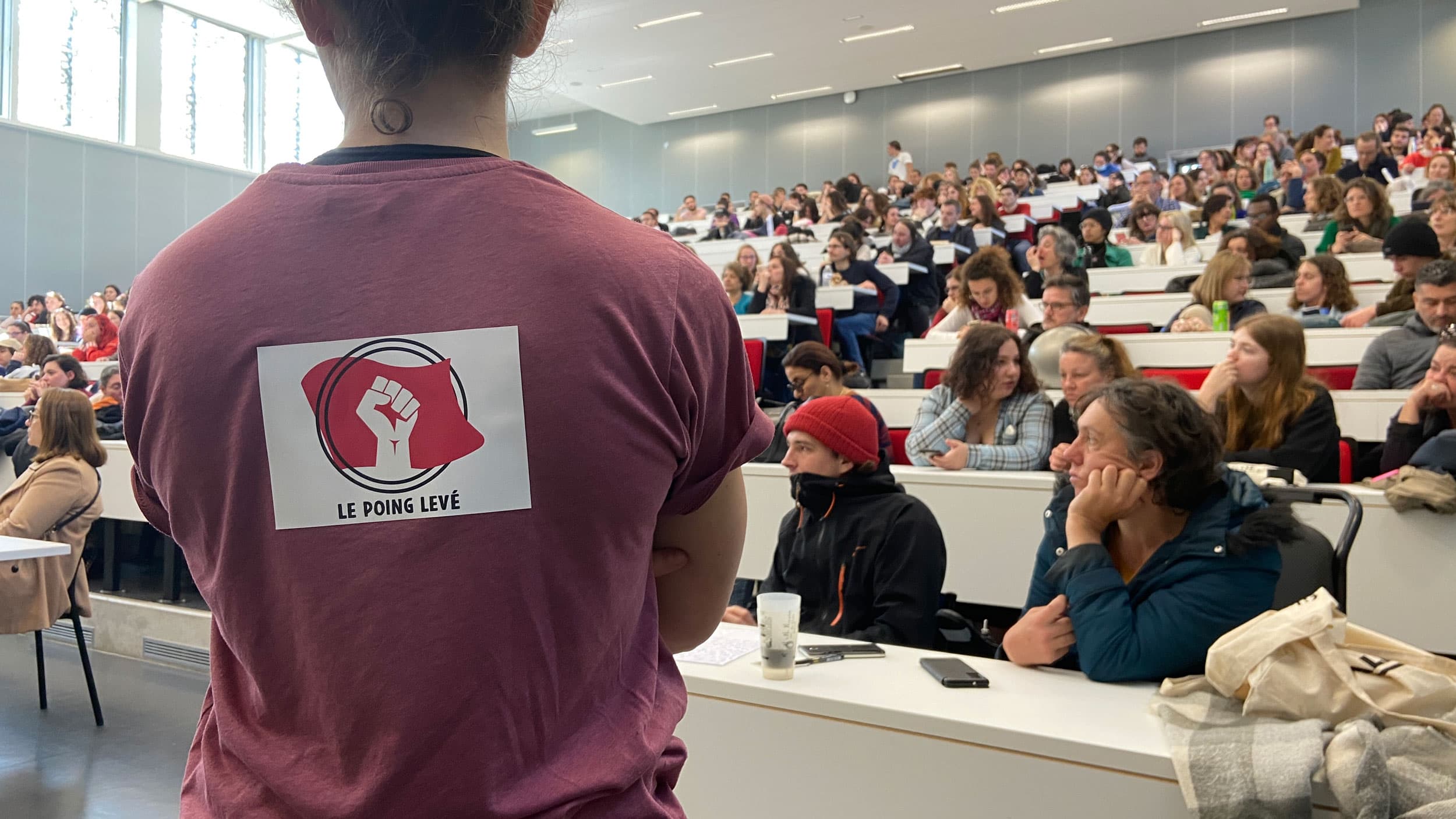 “Fist raised,” reads a decal on the back of a student attending a planning meeting before the day’s march.
