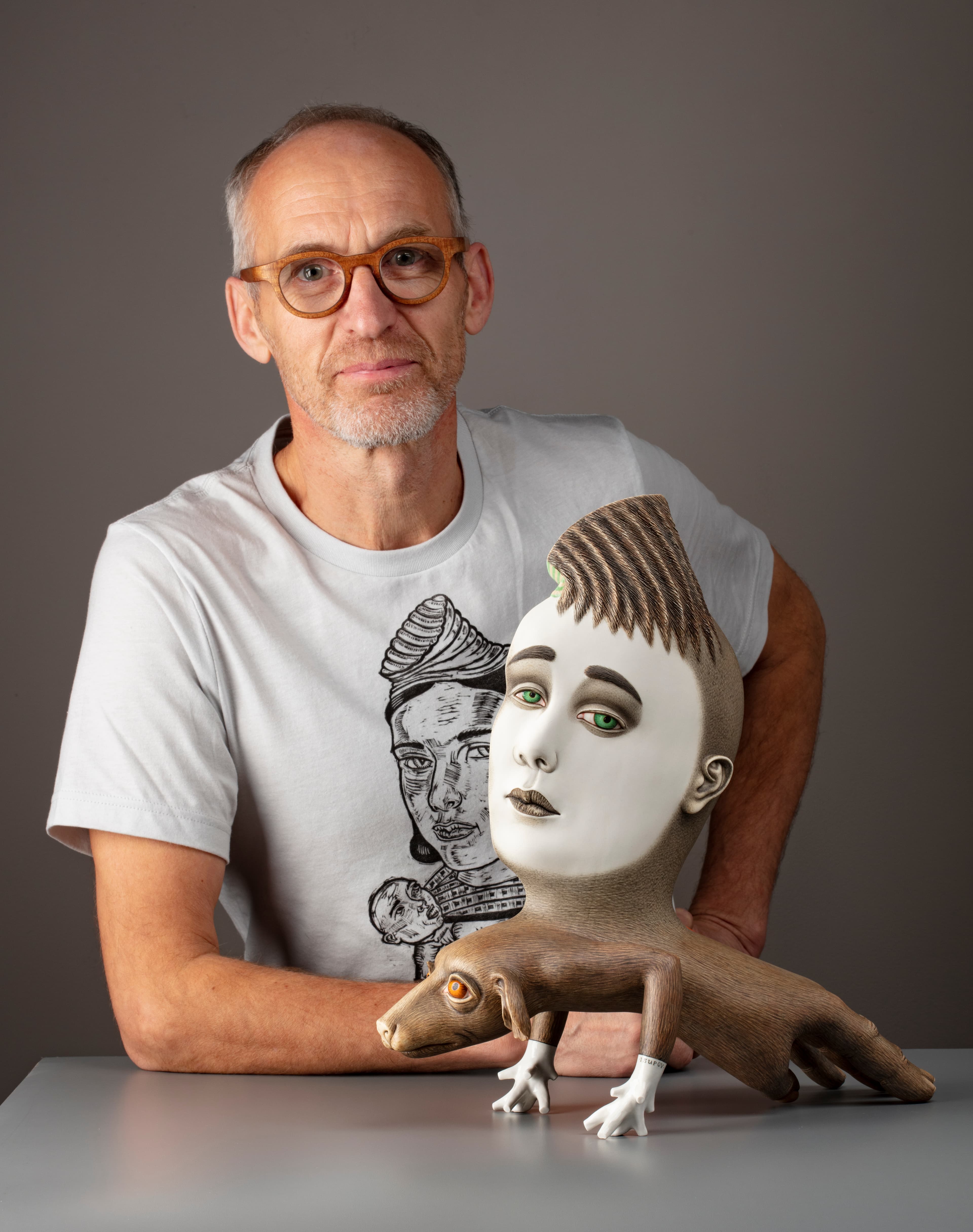 Sergei Isupov, who lives in western Massachusetts, holds up one of his pieces of artwork.