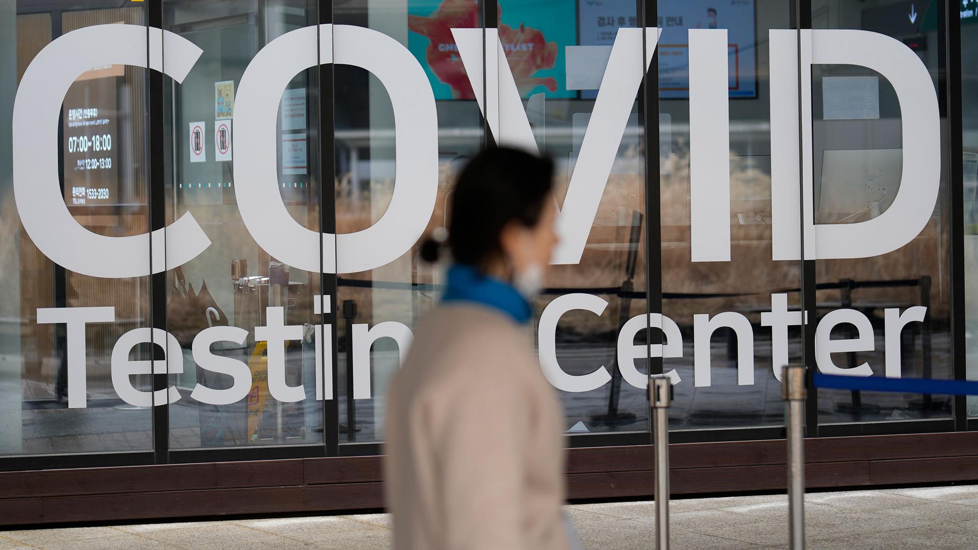 A woman walks outside of a COVID-19 testing center at the Incheon International Airport In Incheon, South Korea, on Feb. 10, 2023. 