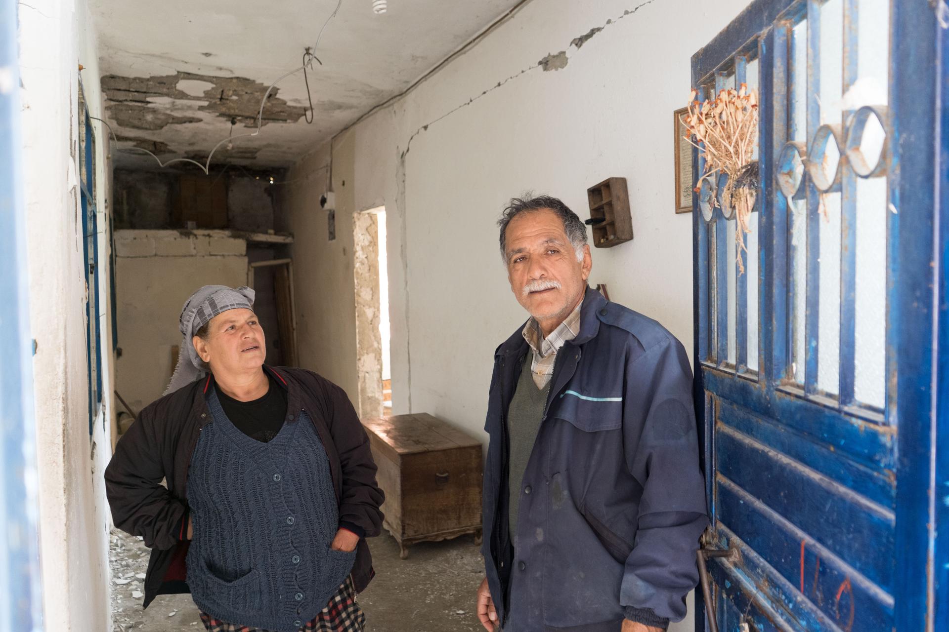 a man and woman inside a damaged house