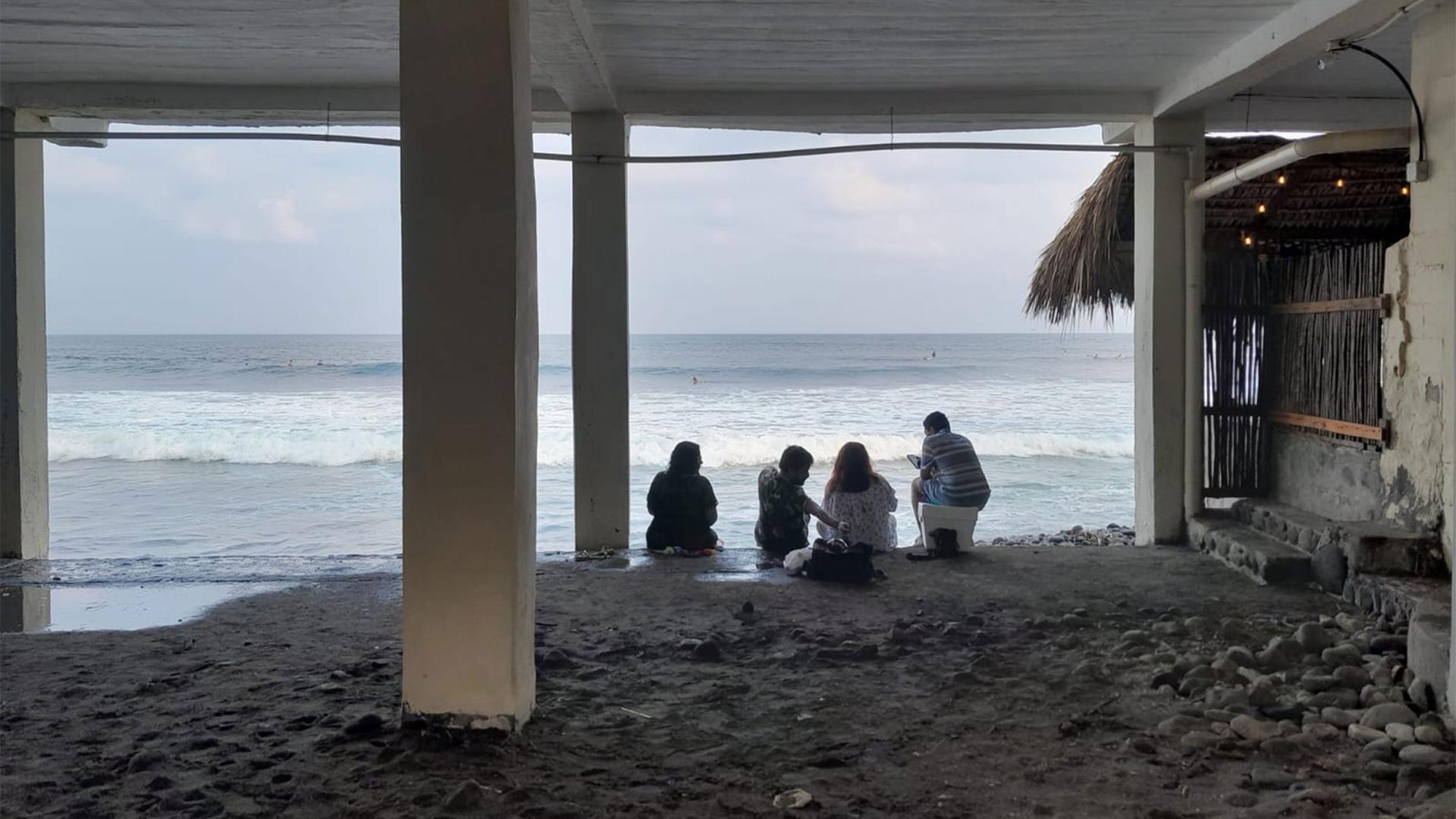 People sit along Bitcoin Beach in El Zonte, El Salvador.