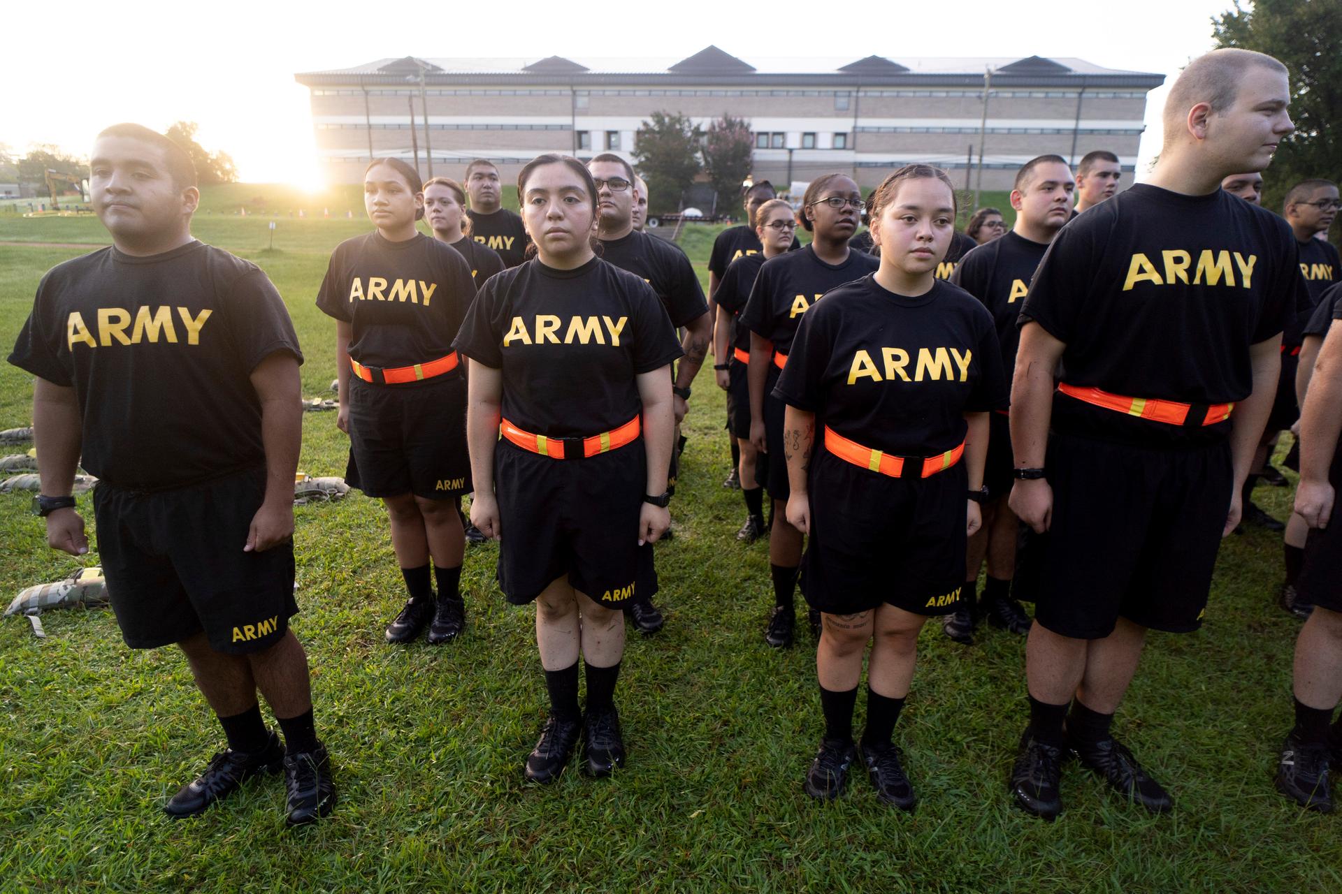 US Army recruits in assumed position, wearing black t-shirts that have "ARMY" written across in bold yellow letters