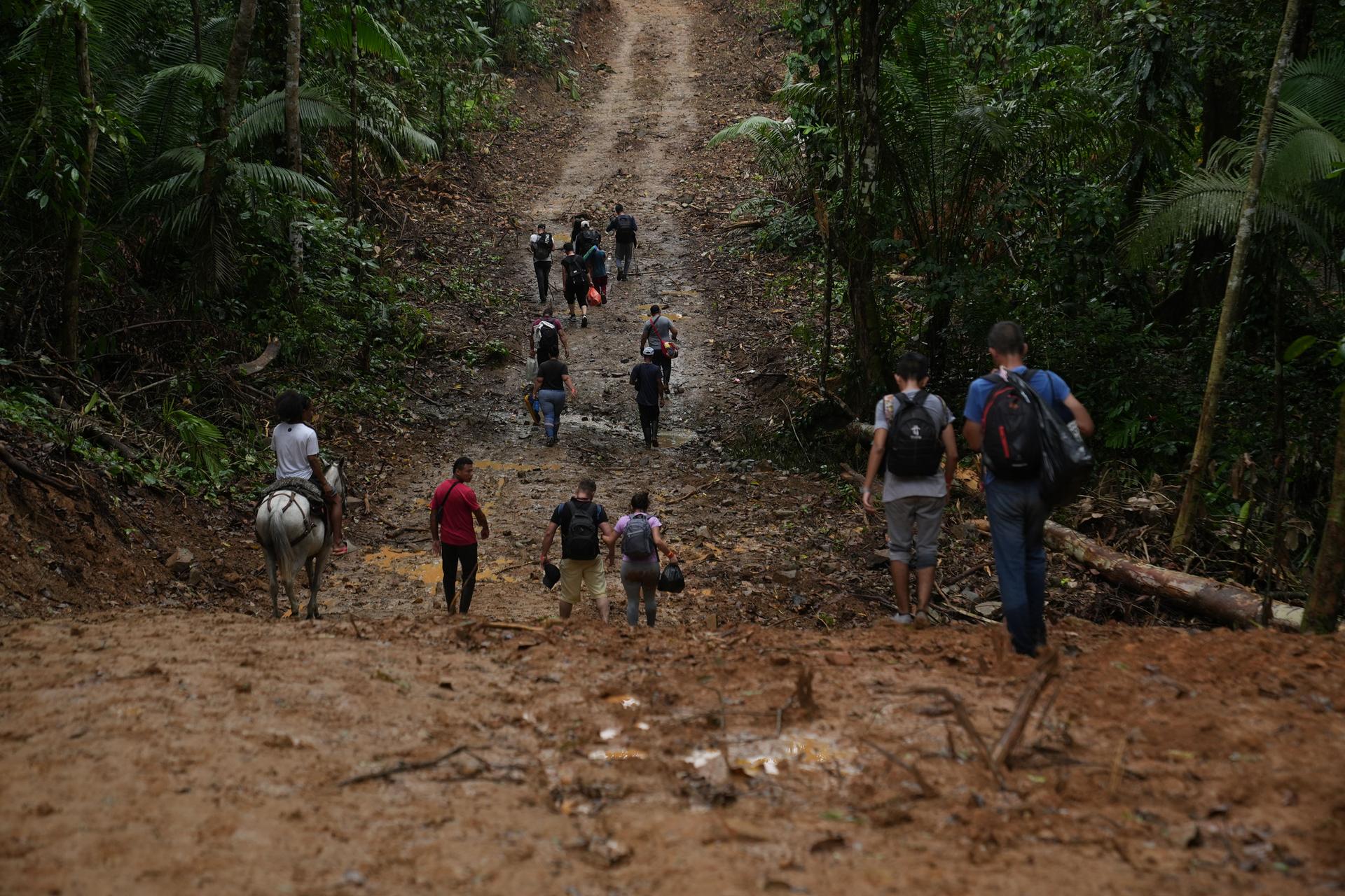 A group of Venezuelan migrants begins the grueling three day trek across the Darien Gap, as they leave the Colombian village of Capurgana. 