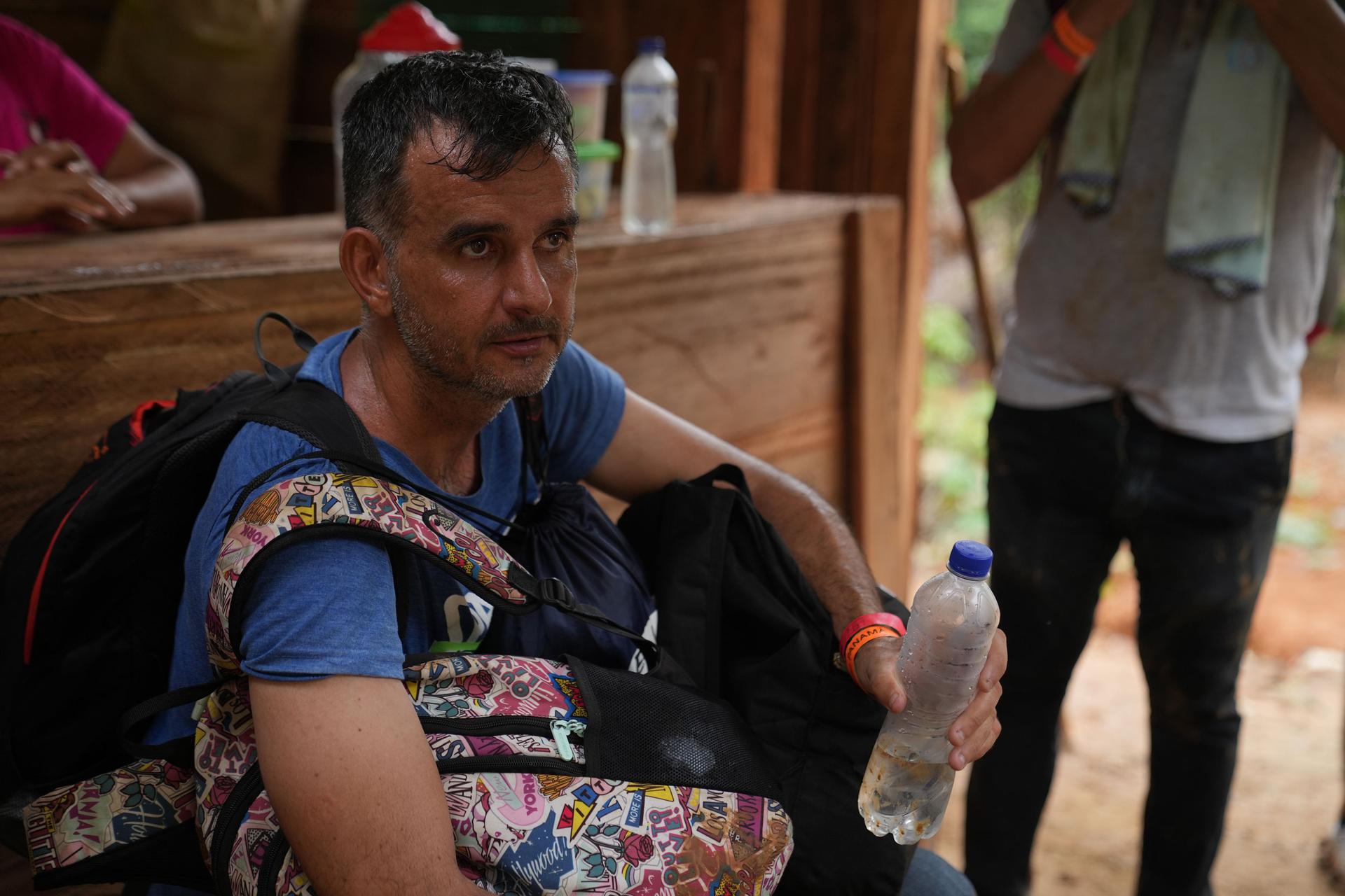 Onelio Bravo takes a break from walking at a rest stop in the Darien Gap. The trek across the jungle takes at least three days.