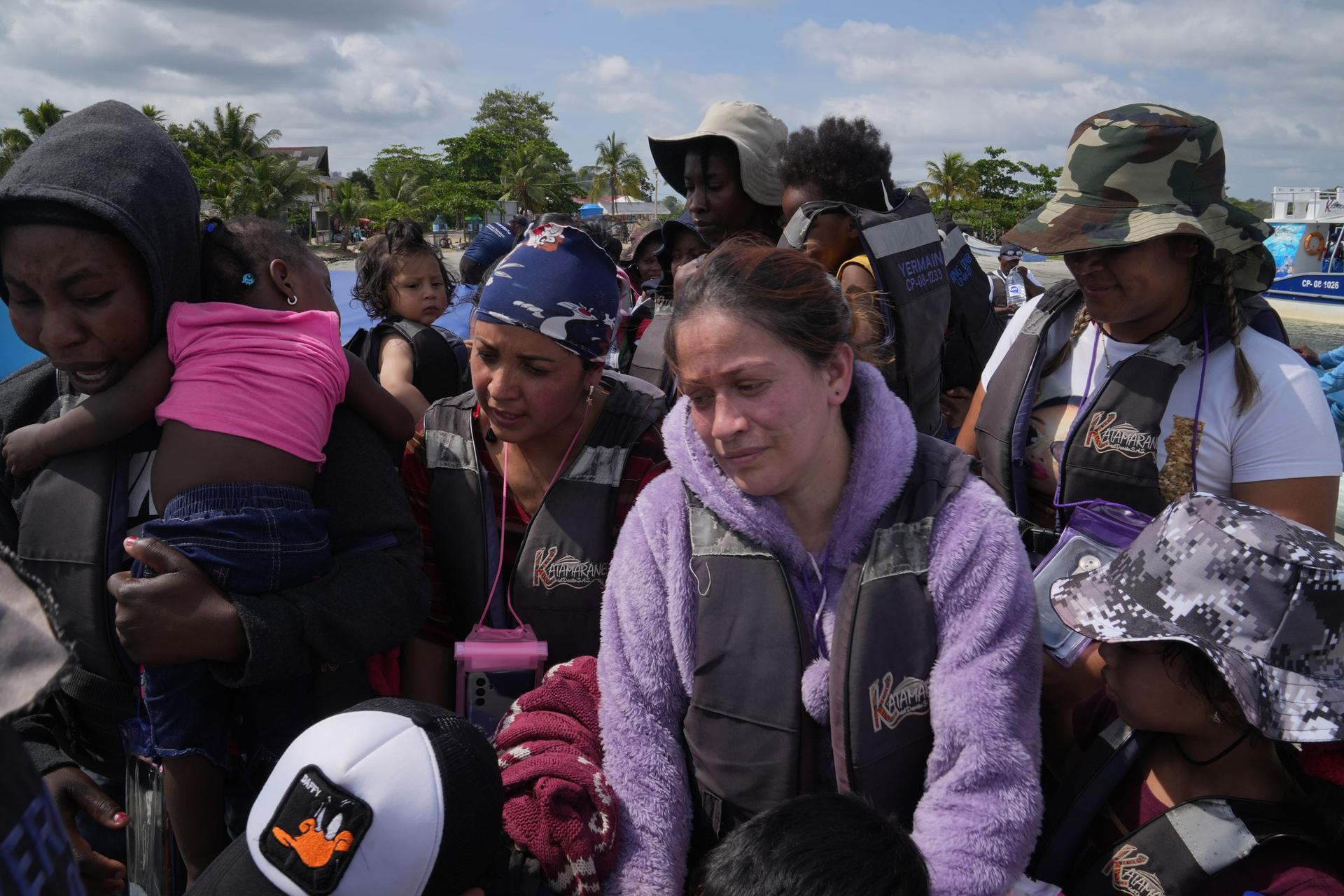 Migrants get ready to board a boat in Necocli, Colombia, one of the last stops before their trek across the jungle begins.