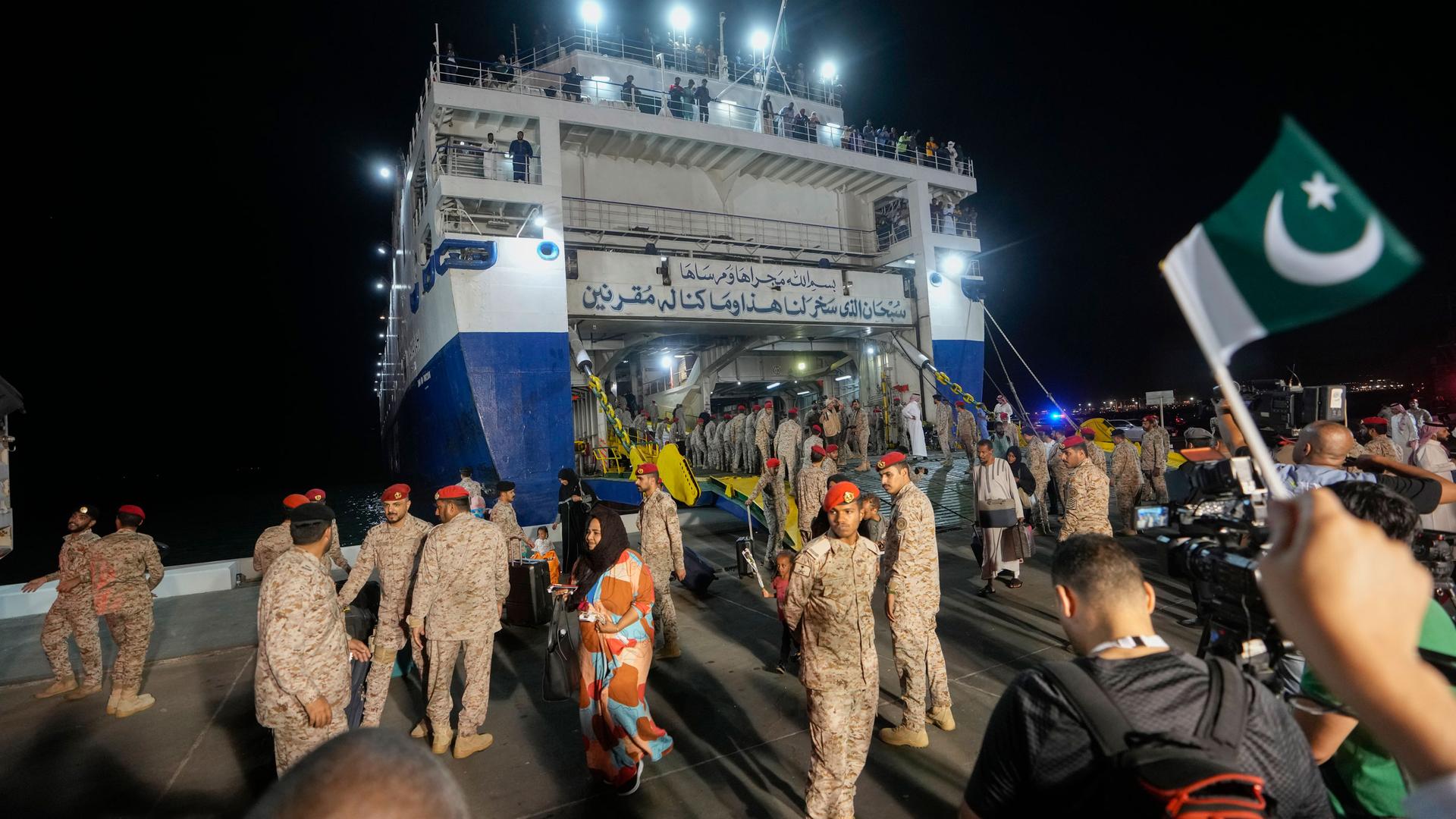 Evacuees leave Saudi Amanah ship after landing at Jeddah port, Saudi Arabia, May 4, 2023. 