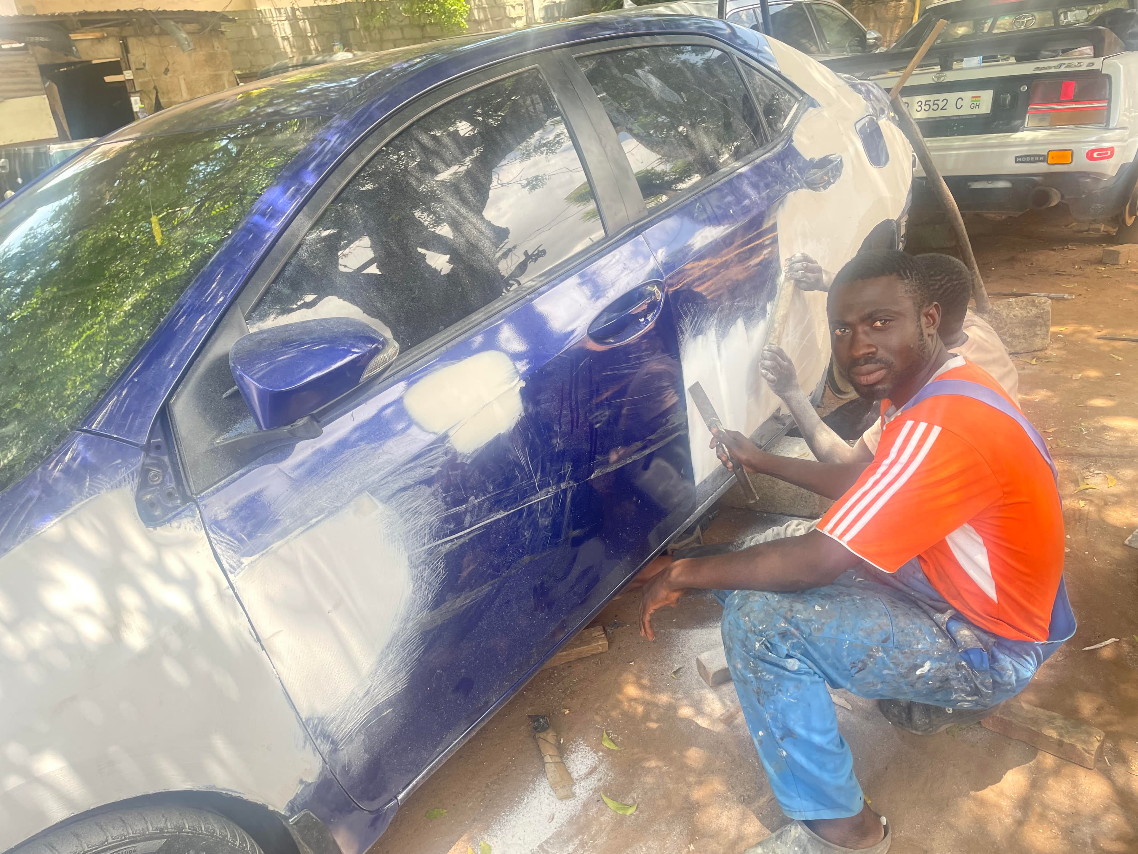 man repairing car