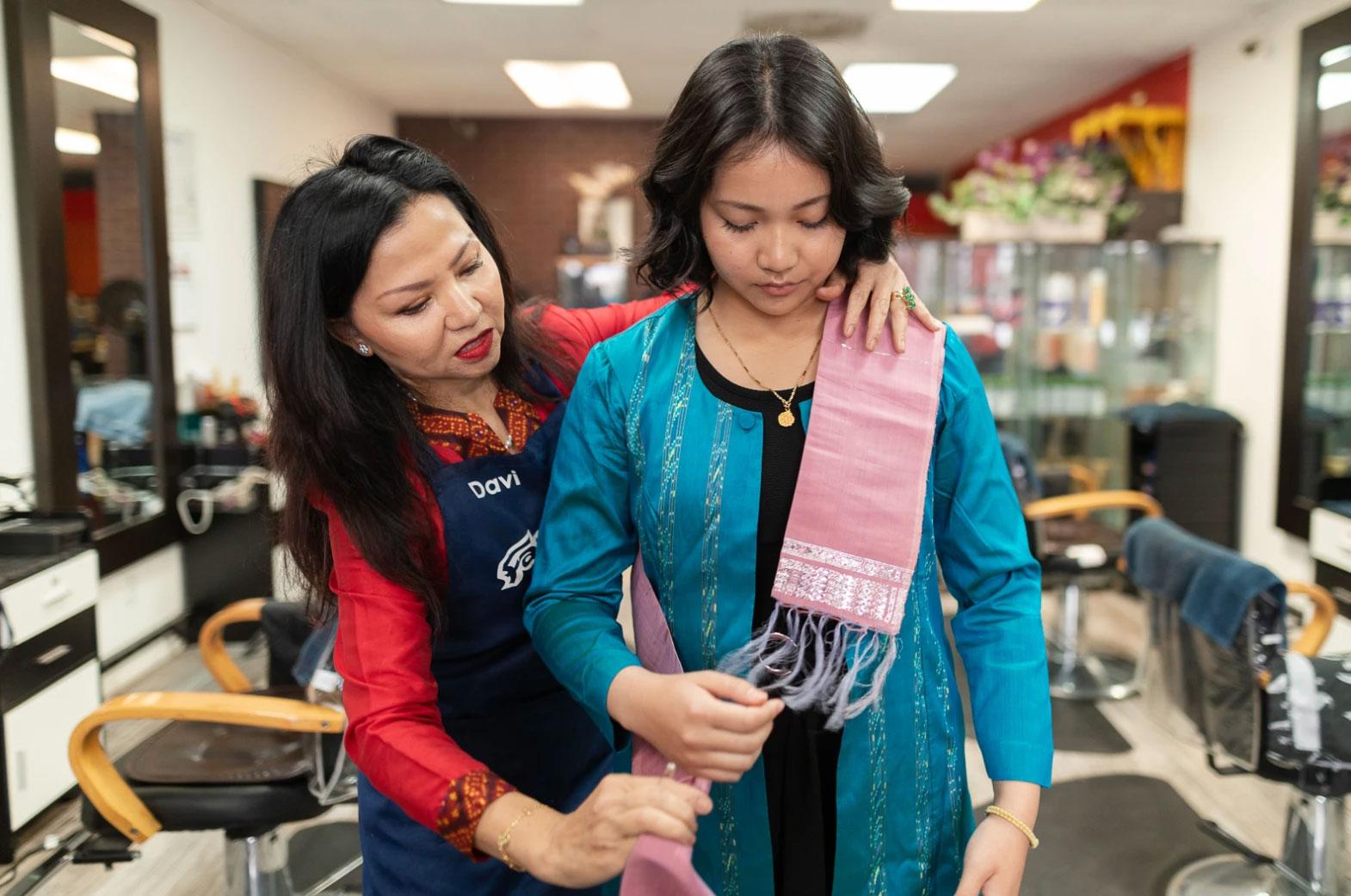 Ariya Tok gets help from her mother Dannaly as she puts on traditional Cambodian attire to attend her graduation ceremony at California State University Long Beach.
