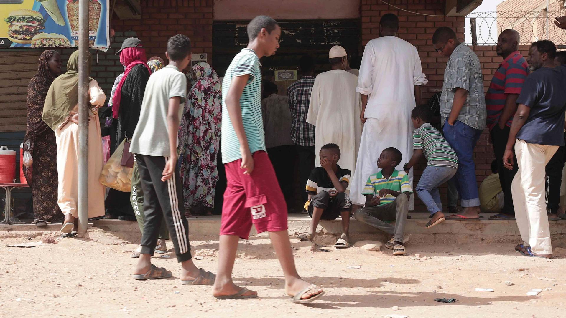 People line up in front of a bakery during a ceasefire in Khartoum, Sudan, Saturday, May 27, 2023. 