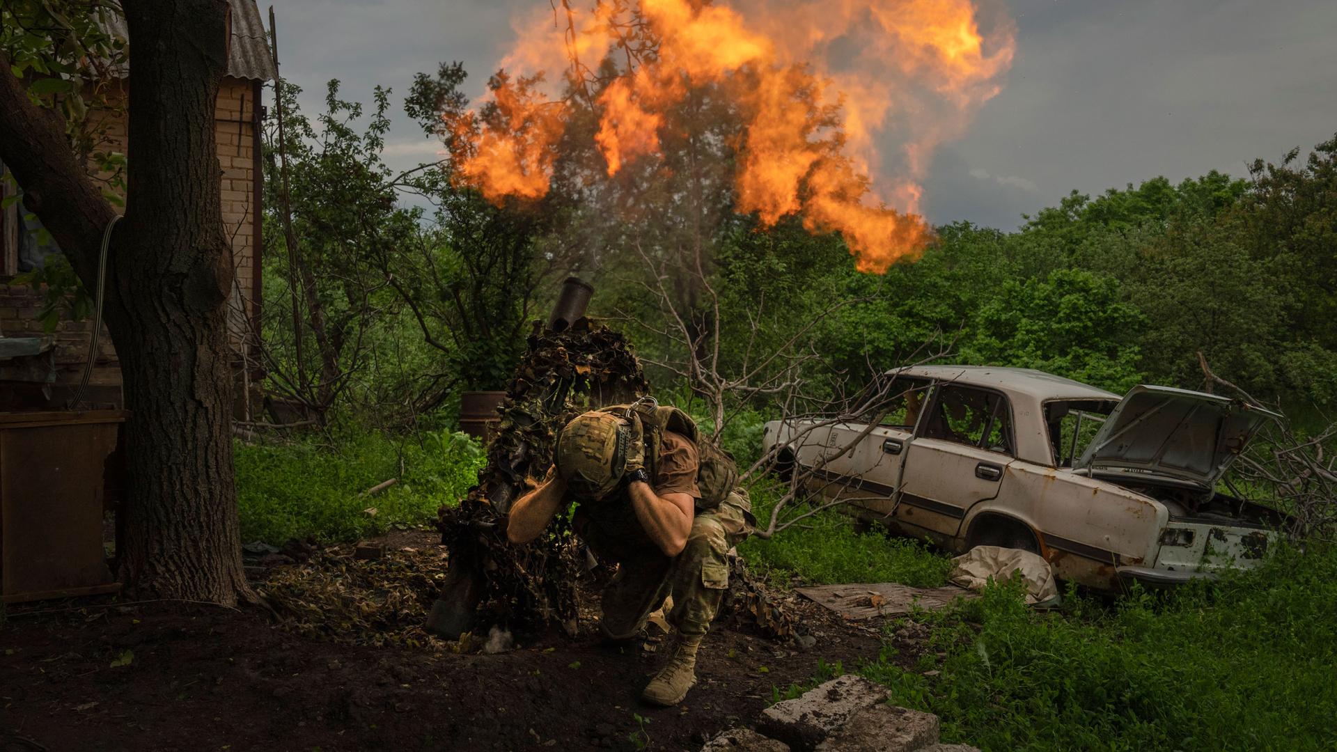 A Ukrainian soldier fires a mortar at Russian positions on the frontline near Bakhmut, Donetsk region, Ukraine, Sunday, May 28, 2023.