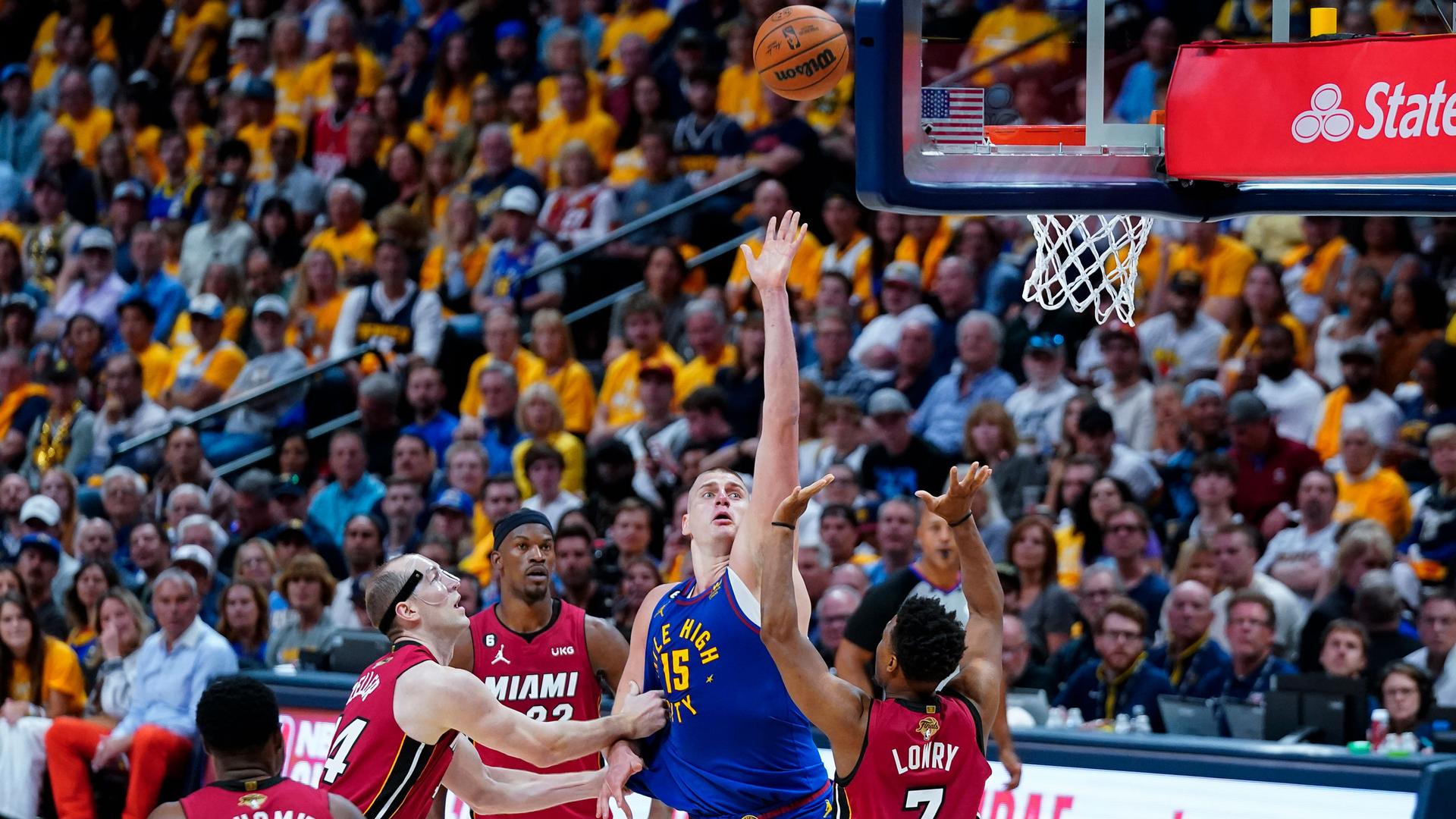 Denver Nuggets center Nikola Jokić (15) shoots over Miami Heat guard Kyle Lowry (7) during the second half of Game 1 of basketball's NBA Finals, Thursday, June 1, 2023, in Denver. 