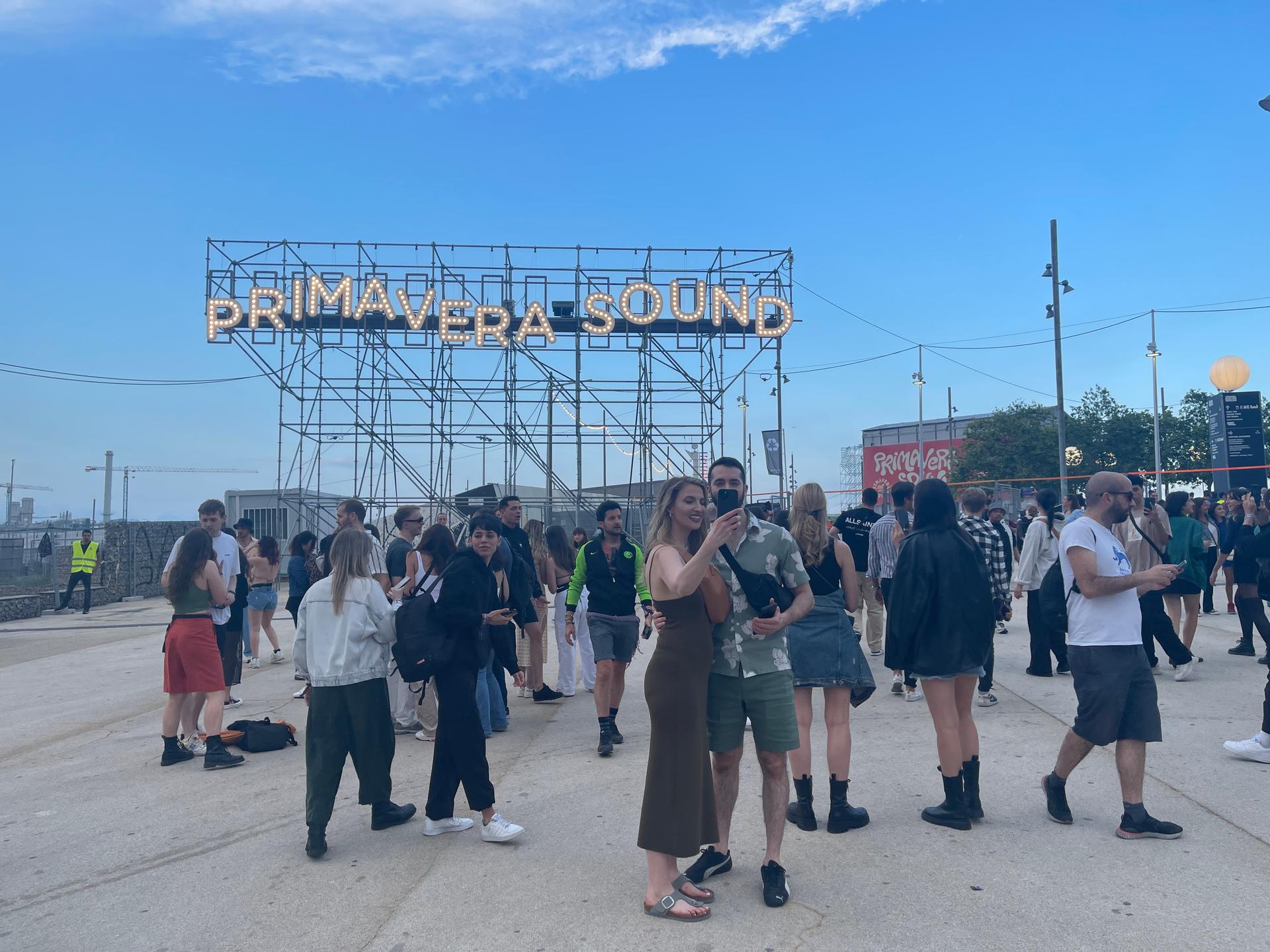 People standing near a large fixture that spells Primavera Sound