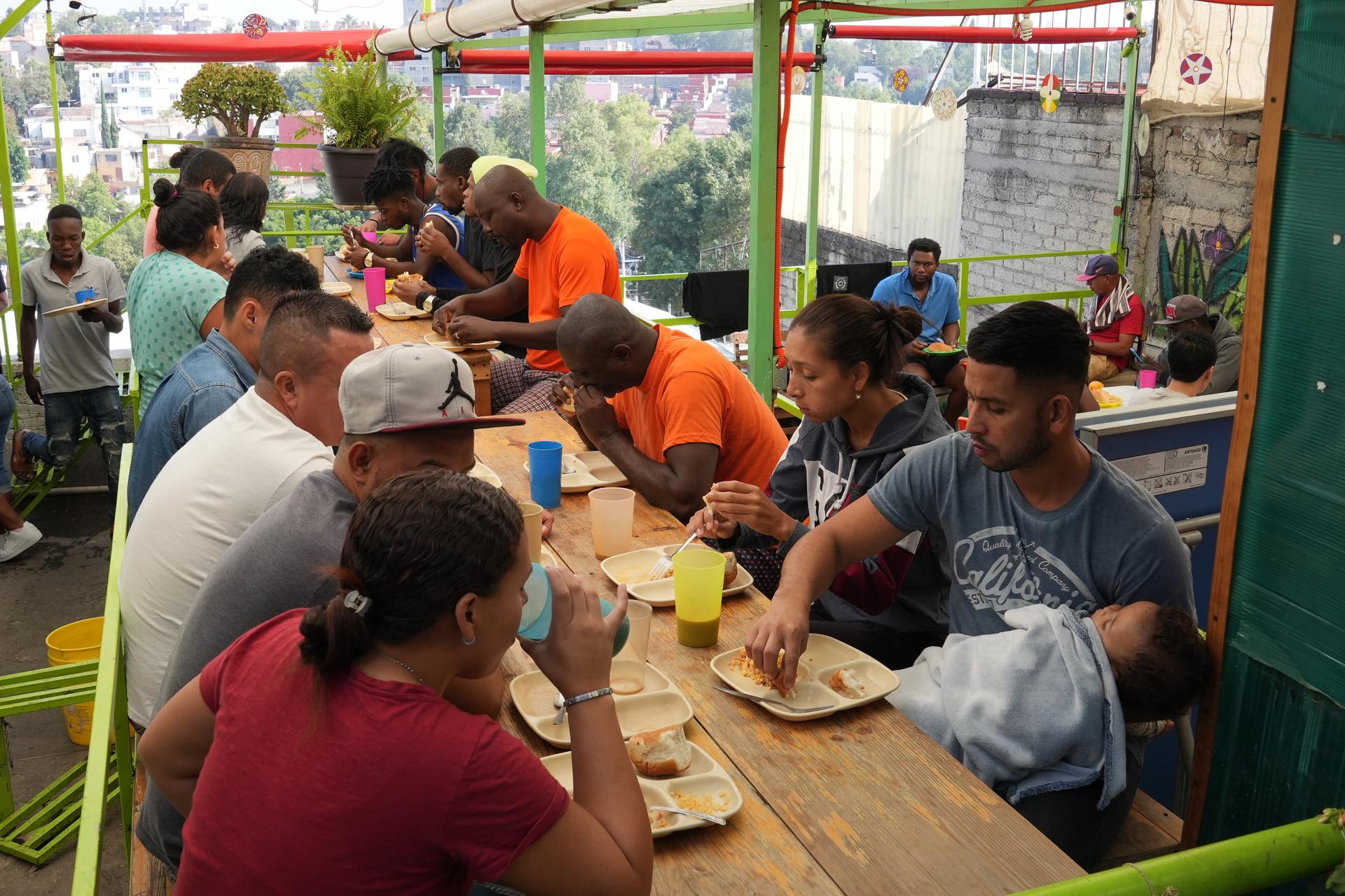 Migrants have breakfast at the Casa Tochan shelter in Mexico City.