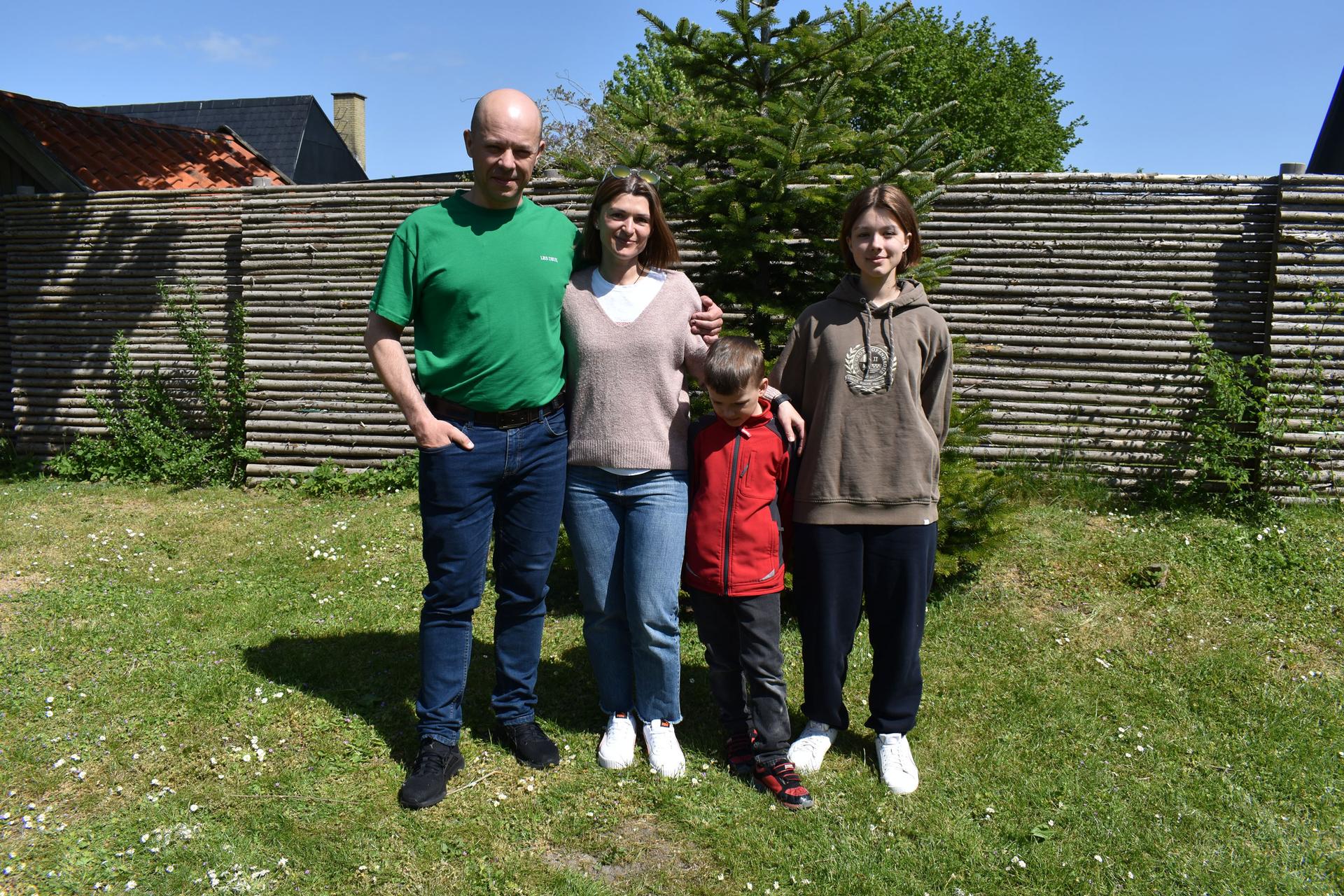 The Olinyk family poses for a portrait in the backyard in Hvidovre, Denmark, May 18, 2023.