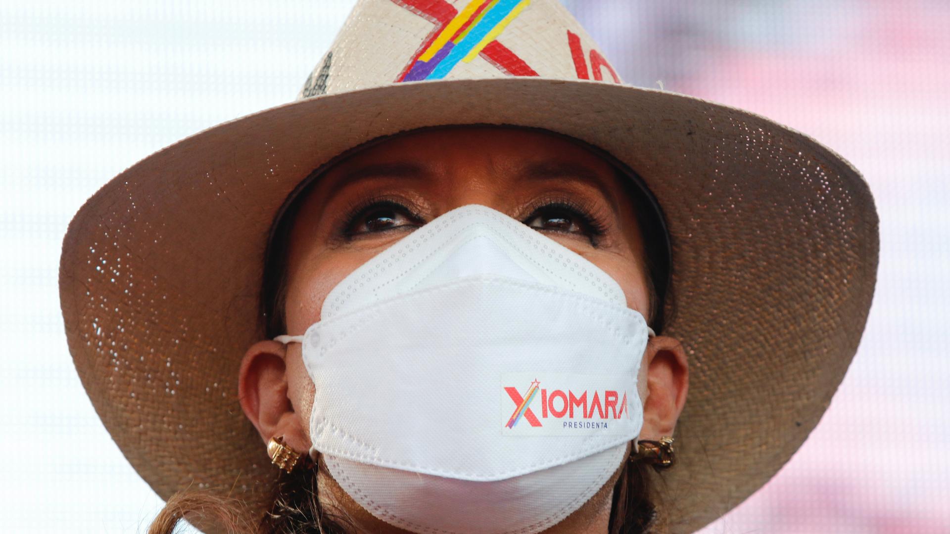 close-up shot of Honduran President Castro wearing a mask