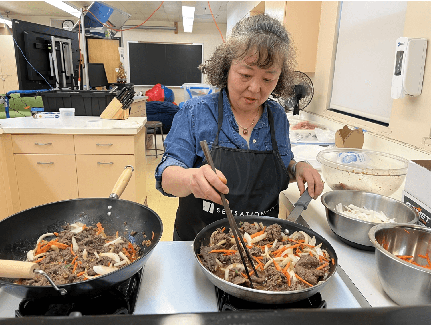 Seon Joo Oh cooks beef bulgogi during a recent cooking class in Hamilton High School's culinary room.