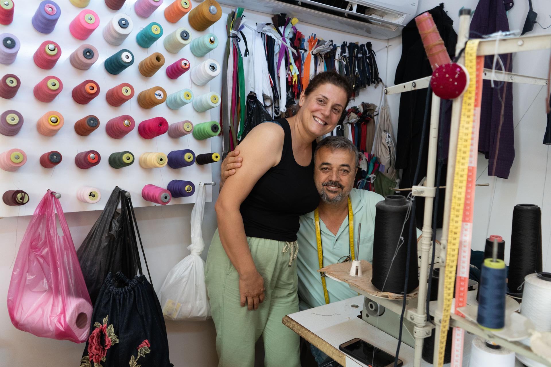 Semih and Serap Bozaydi reopened their tailoring shop in a market of small, prefabricated buildings set up by the government.