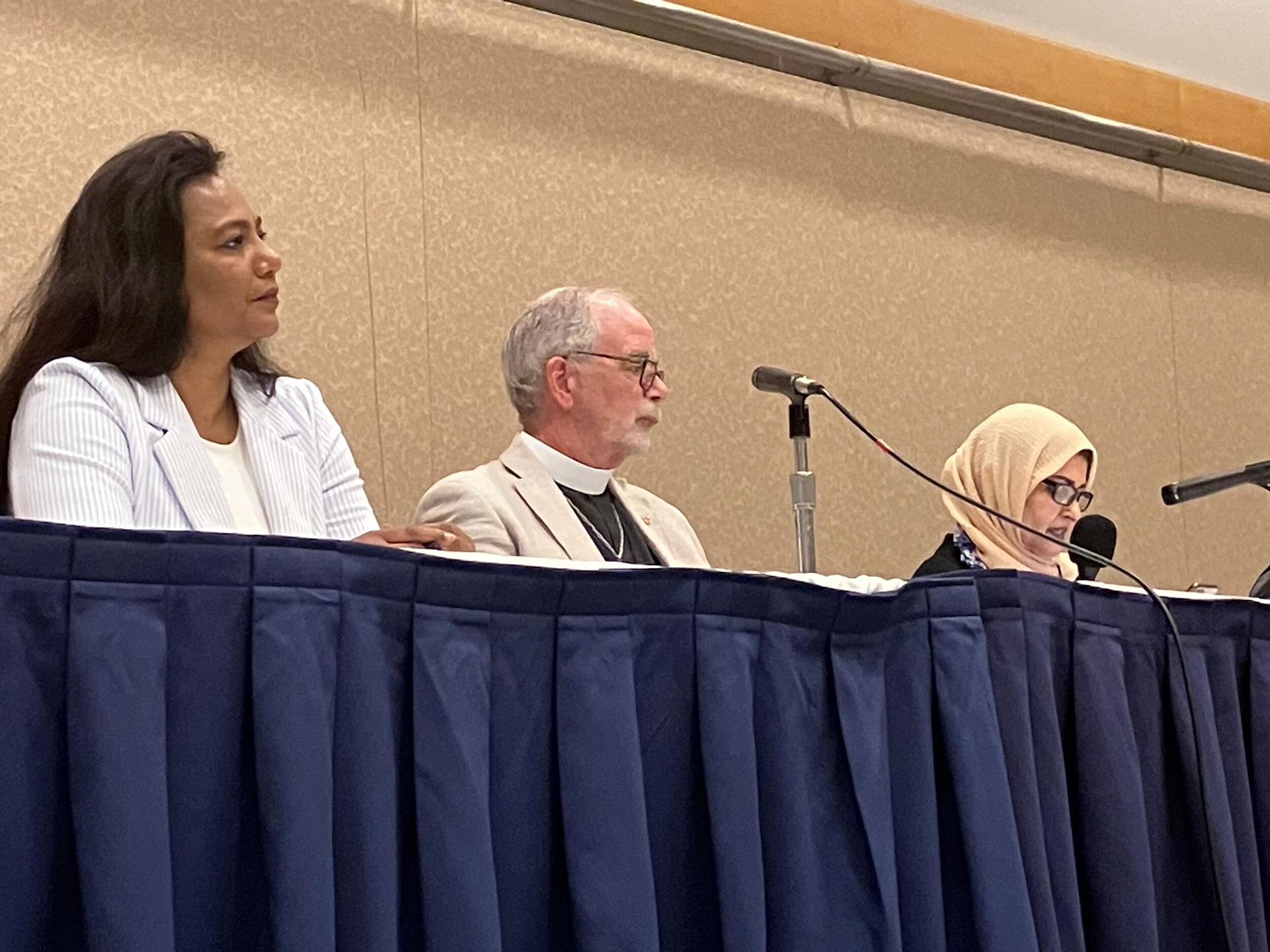 Vijaylakshmi Nadar (left) and Mark Lukens (center) speak on a panel about religious extremism at the Parliament of the World's Religions in Chicago, Aug. 16, 2023.