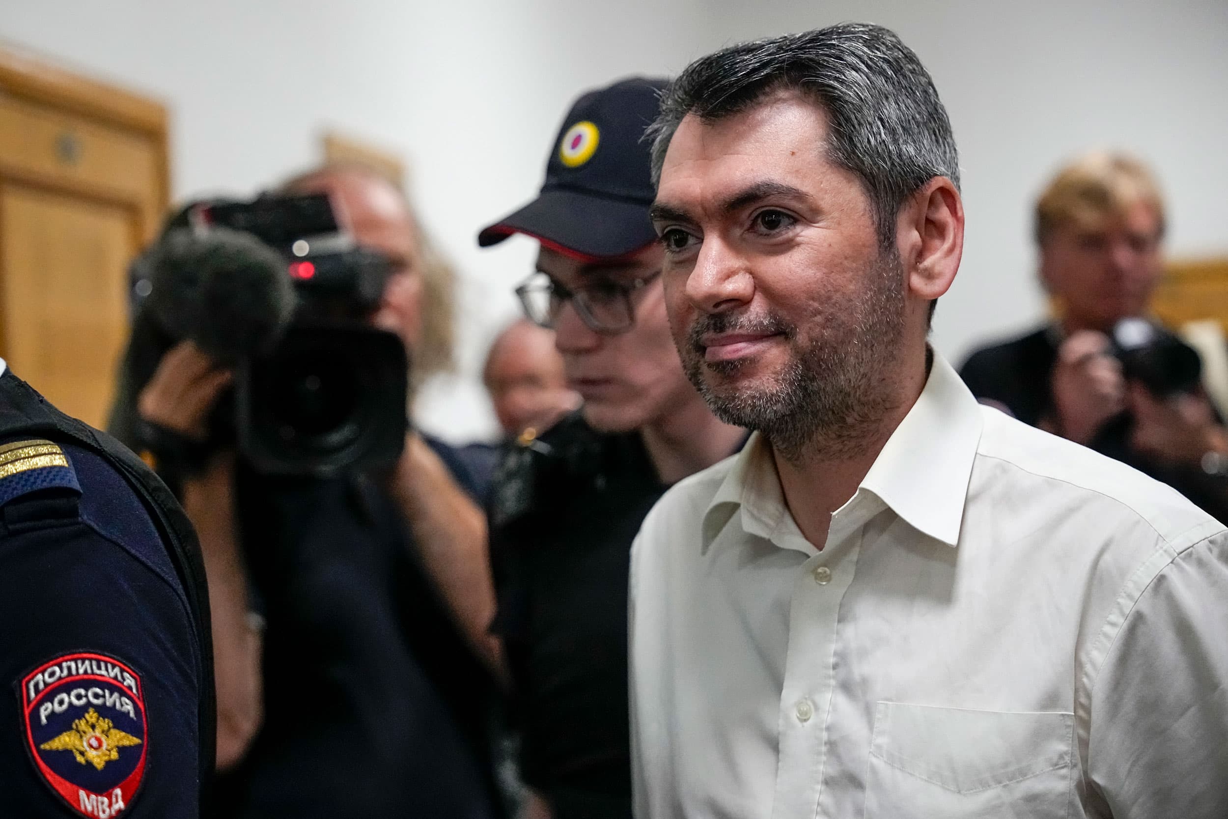 Grigory Melkonyants is escorted from a courtroom after a session in Moscow, Russia, Friday, Aug. 18, 2023.
