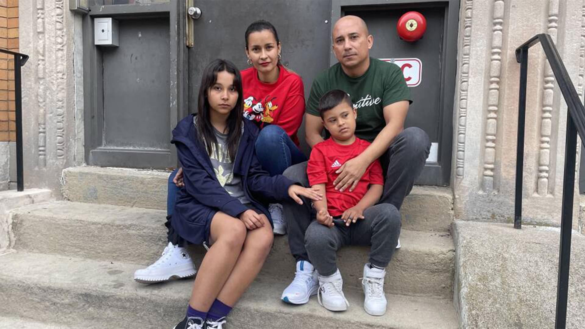 Zhayreth, Adriana, Freddy and Freydar Torres sit on the stoop of their apartment in Dorchester.