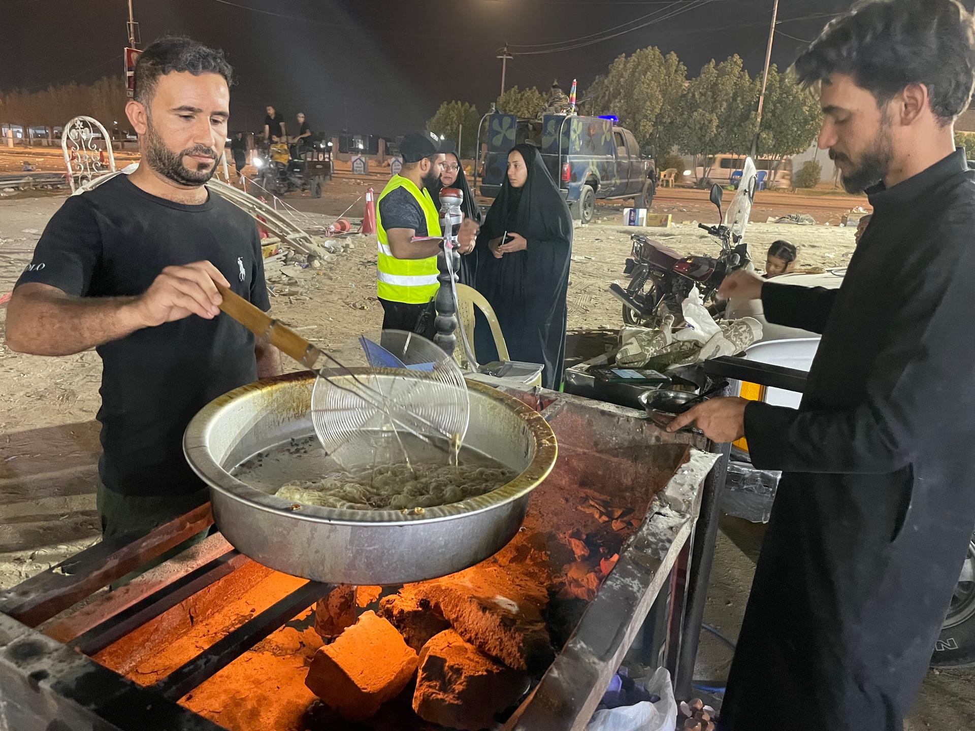 People make food to serve for free to those on the Arbaeen walk in Iraq, September 2023.