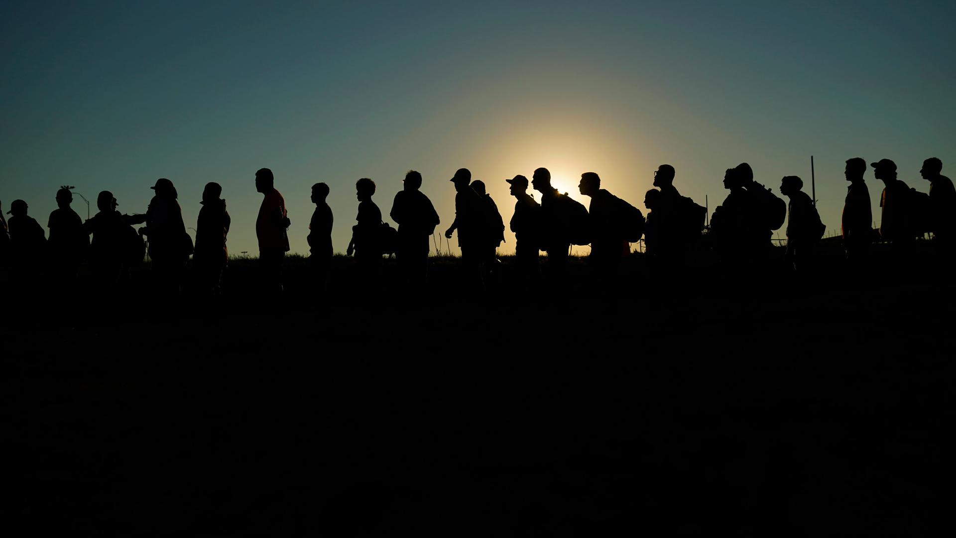 Migrants who crossed the Rio Grande and entered the U.S. from Mexico are lined up for processing by US Customs and Border Protection, Saturday, Sept. 23, 2023, in Eagle Pass, Texas.