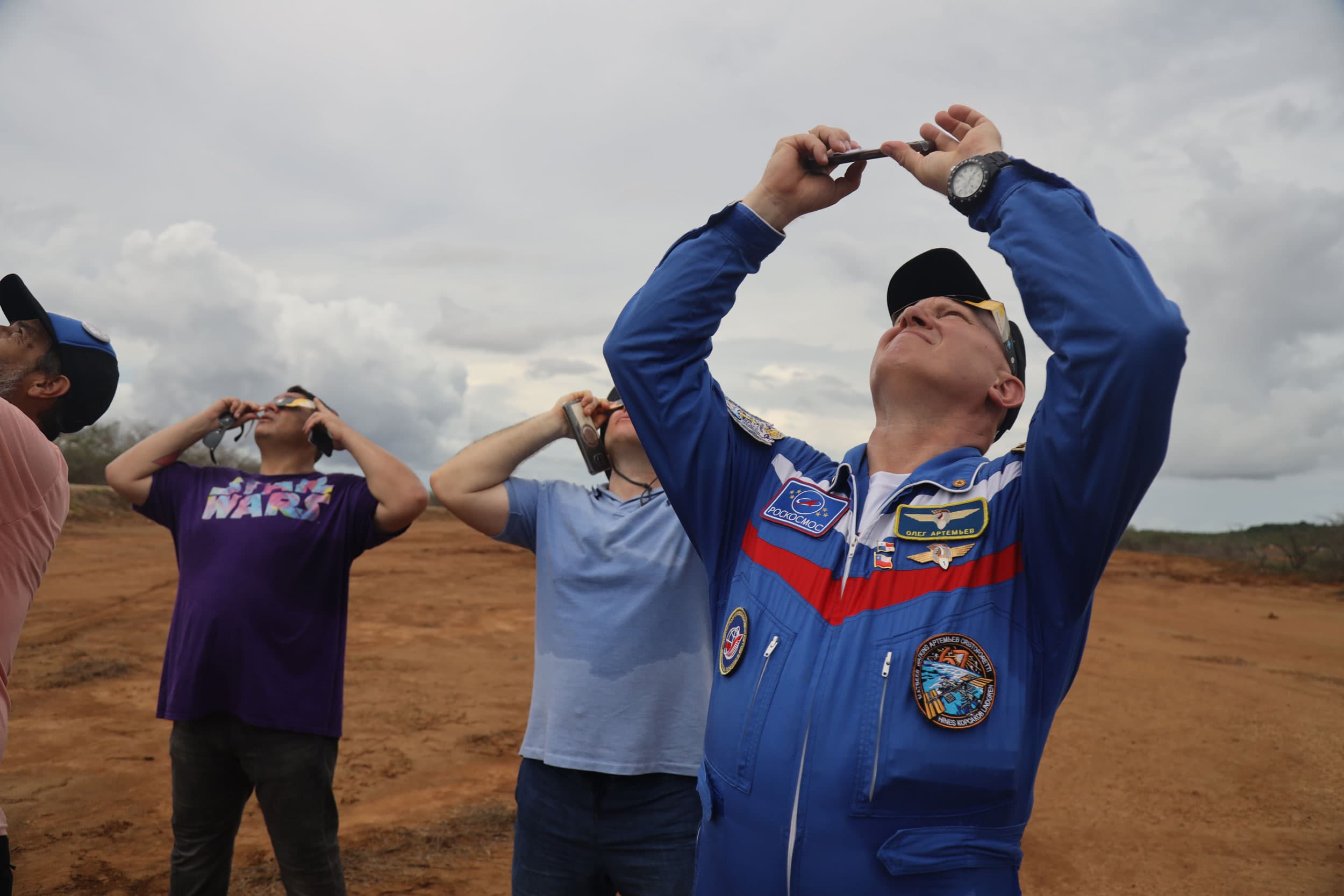 Cosmonaut Oleg Artemyev, from Russia, watches the eclipse with Panamanians.