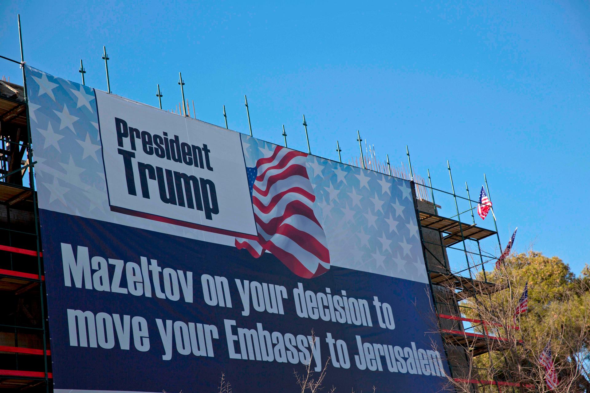 A sign hangs on a building under construction in Jerusalem for the new US Embassy in Jerusalem, Jan. 20, 2017.