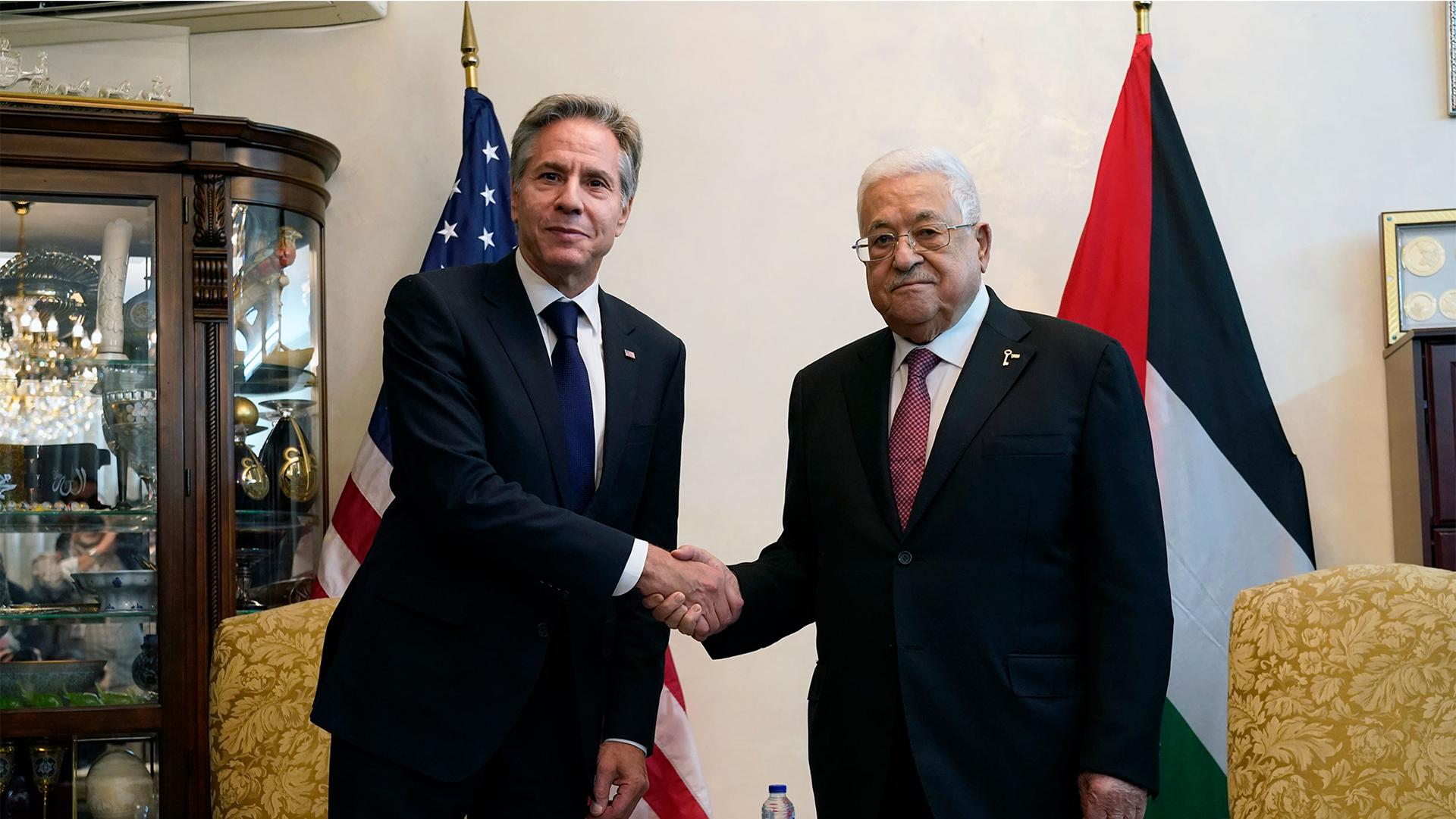 US Secretary of State Antony Blinken, left, shake hands with Palestinian President Mahmoud Abbas, in Amman, Jordan, Oct. 13, 2023.