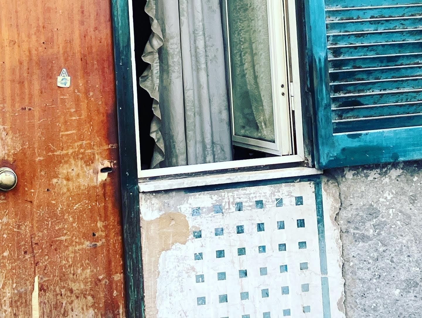 An open window on a quiet street in Naples, Italy, July 2023.