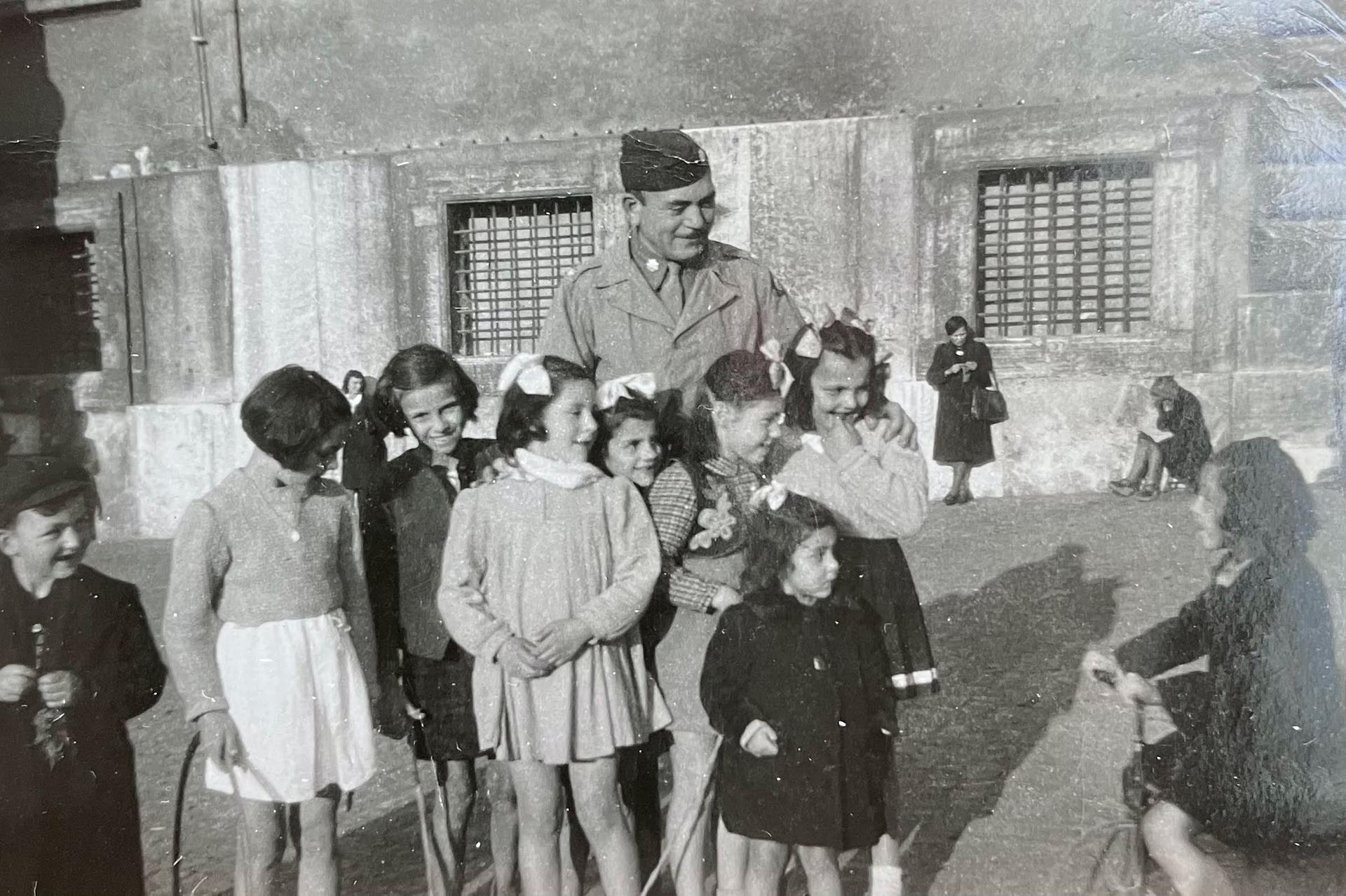 Lt. Col. Manuel E. Lichtenstein interacts with children in southern Italy, 1945. 