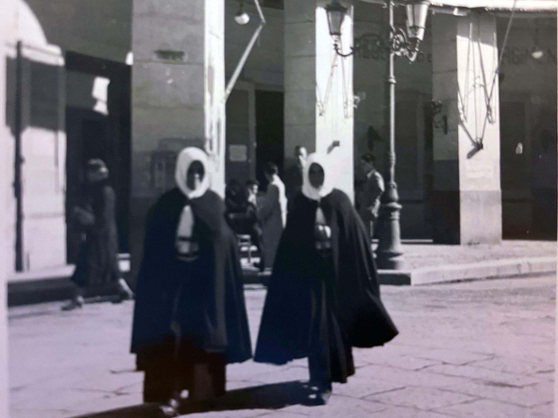Two nuns, midstep in a town square in southern Italy, 1944.