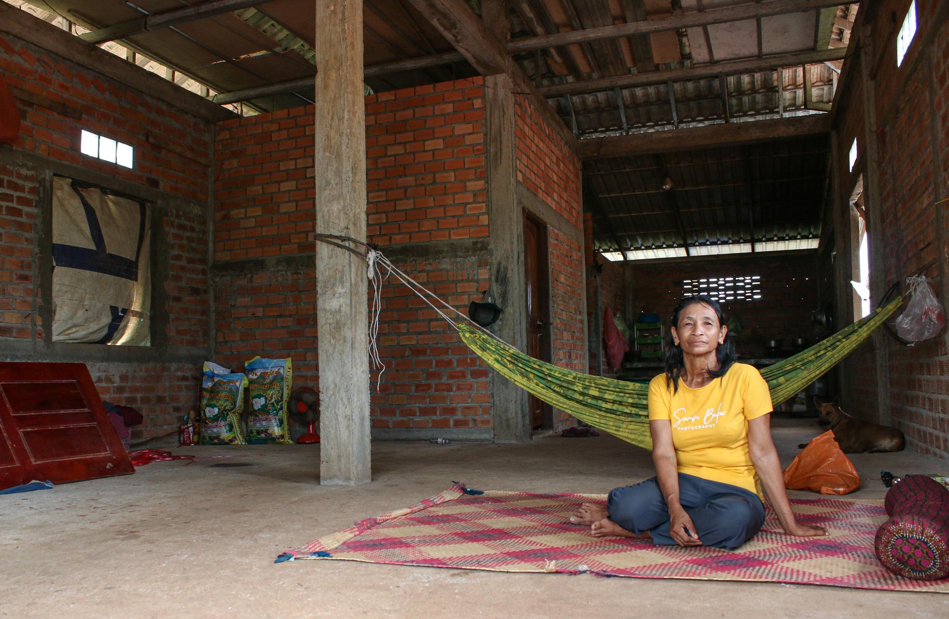 A woman sitting on the floor of a home