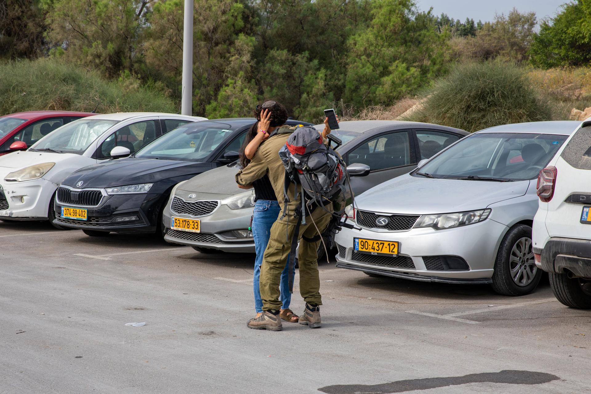 A mother and son greet each other on the edges of Ashkelon, where soldiers are on leave from fighting in Gaza.