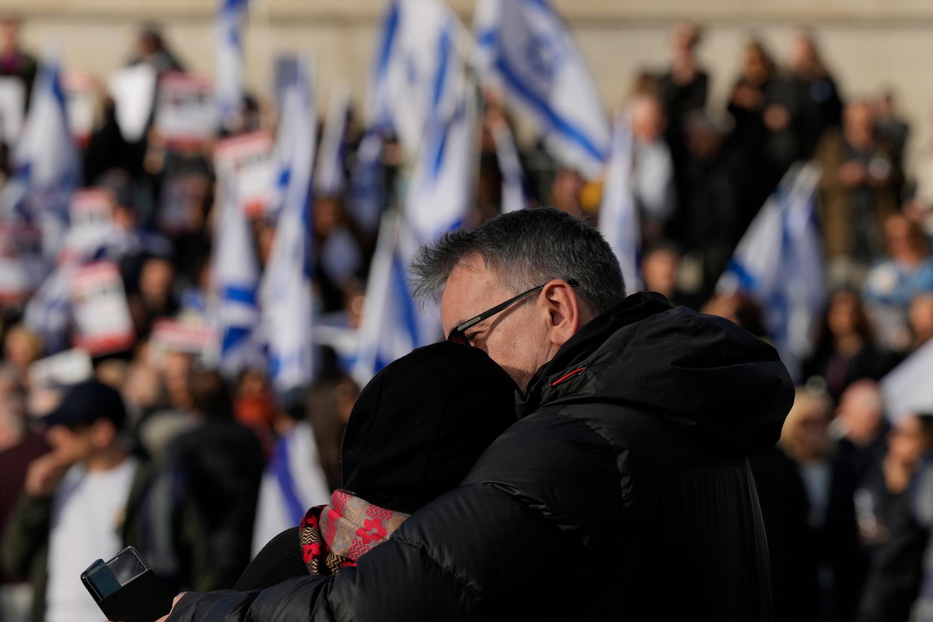 A couple embrace during a protest in Trafalgar Square, London, Sunday, Oct. 22, 2023. They are demanding the release of all hostages allegedly taken by the militant group Hamas.