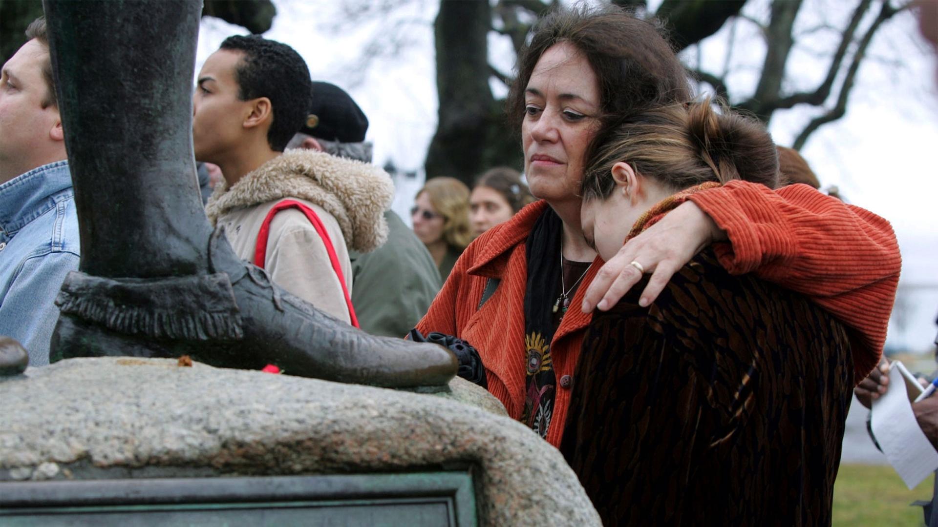Native American supporter Deborah Theodore, left, of Belmont, Mass., and her daughter, Sofia Theodore-Pierce stand by the statue of Massasoit on Cole's Hill in Plymouth, Mass., during the 35th National Day of Mourning, Nov. 25, 2004.
