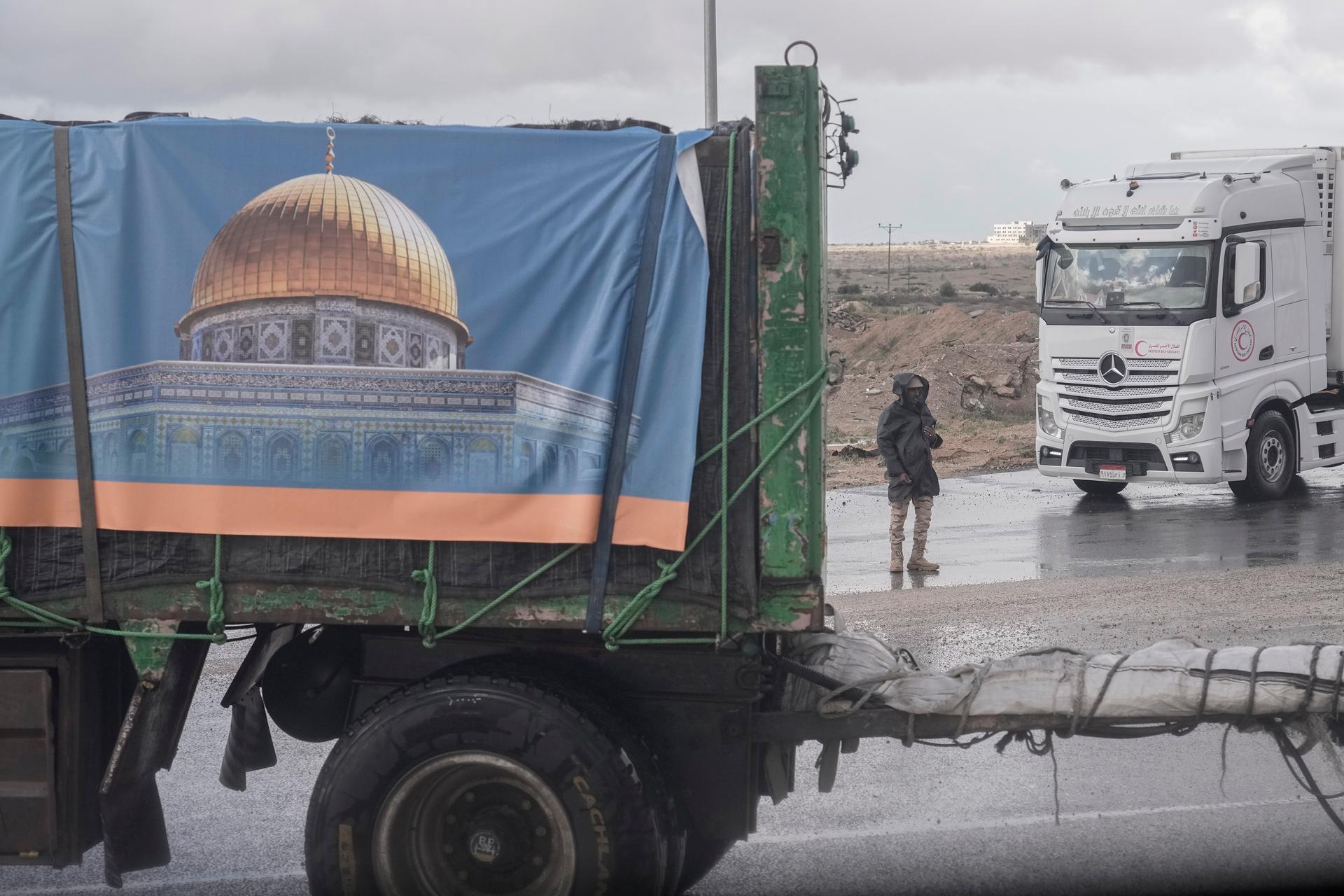 Trucks carrying humanitarian aid line up to cross Rafah crossing port on their way to Gaza Strip, in Rafah, Egypt, Nov. 27, 2023.