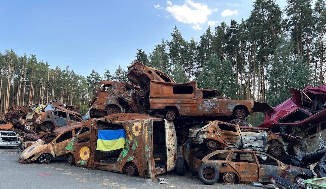 Vehicles burned in the early days of the war are now stacked up as a makeshift memorial in Irpin, Ukraine. The sunflower is considered the national flower.
