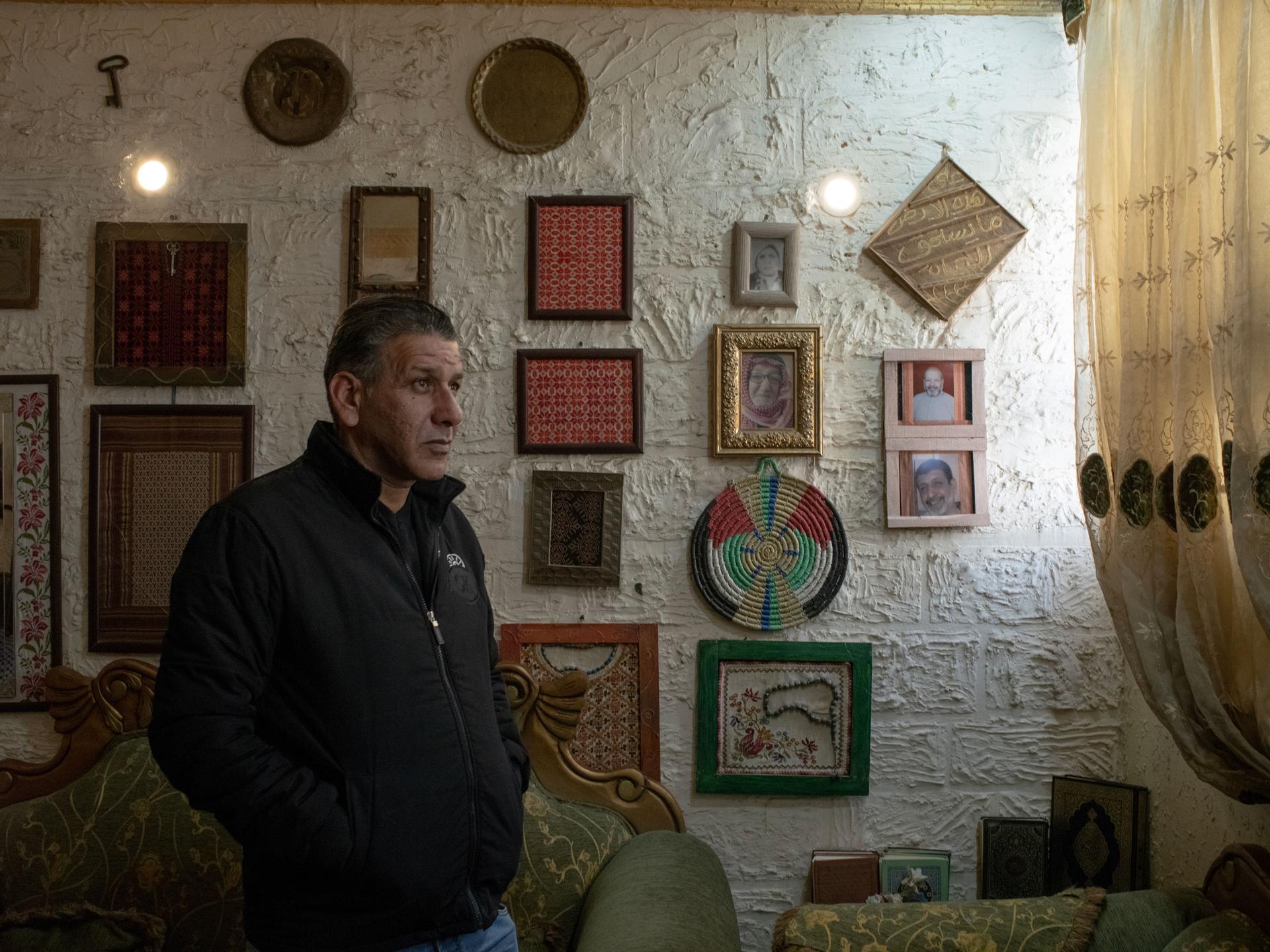 Issa Abu al-Raghib, physiotherapist and author, poses for a picture at his home at the Baqa'a refugee camp, north of the capital Amman, Dec. 12, 2023.