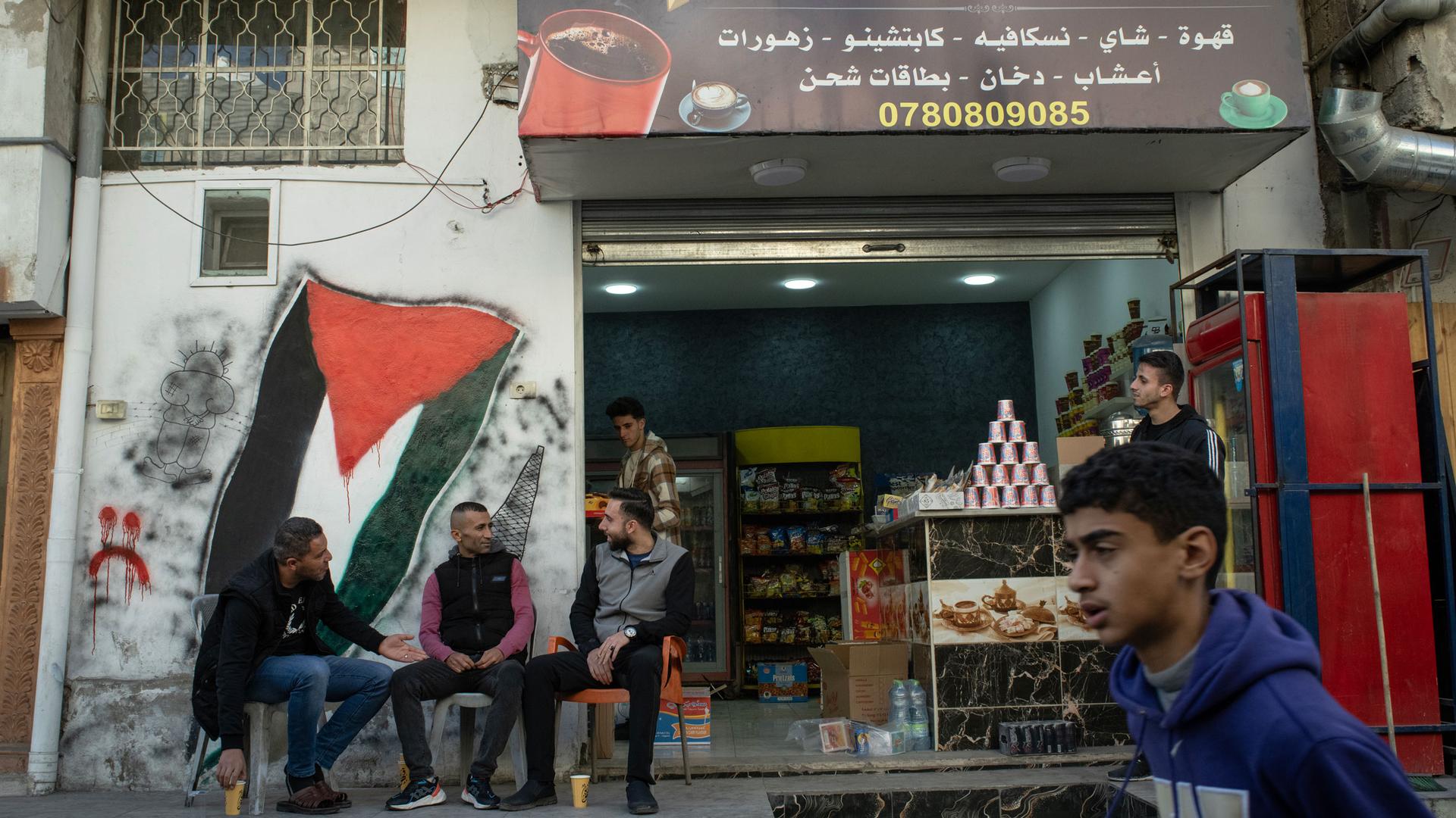 Men sit at a cafe at the Baqa'a refugee camp, north of the capital Amman, Dec. 12, 2023.