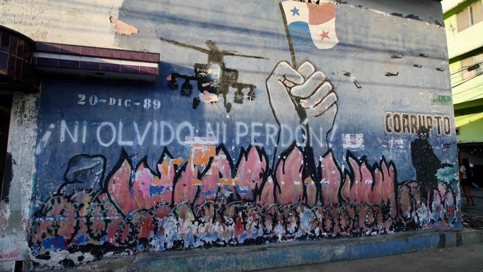 A colorful mural with words in Spanish that read "Never forget, never forgive."