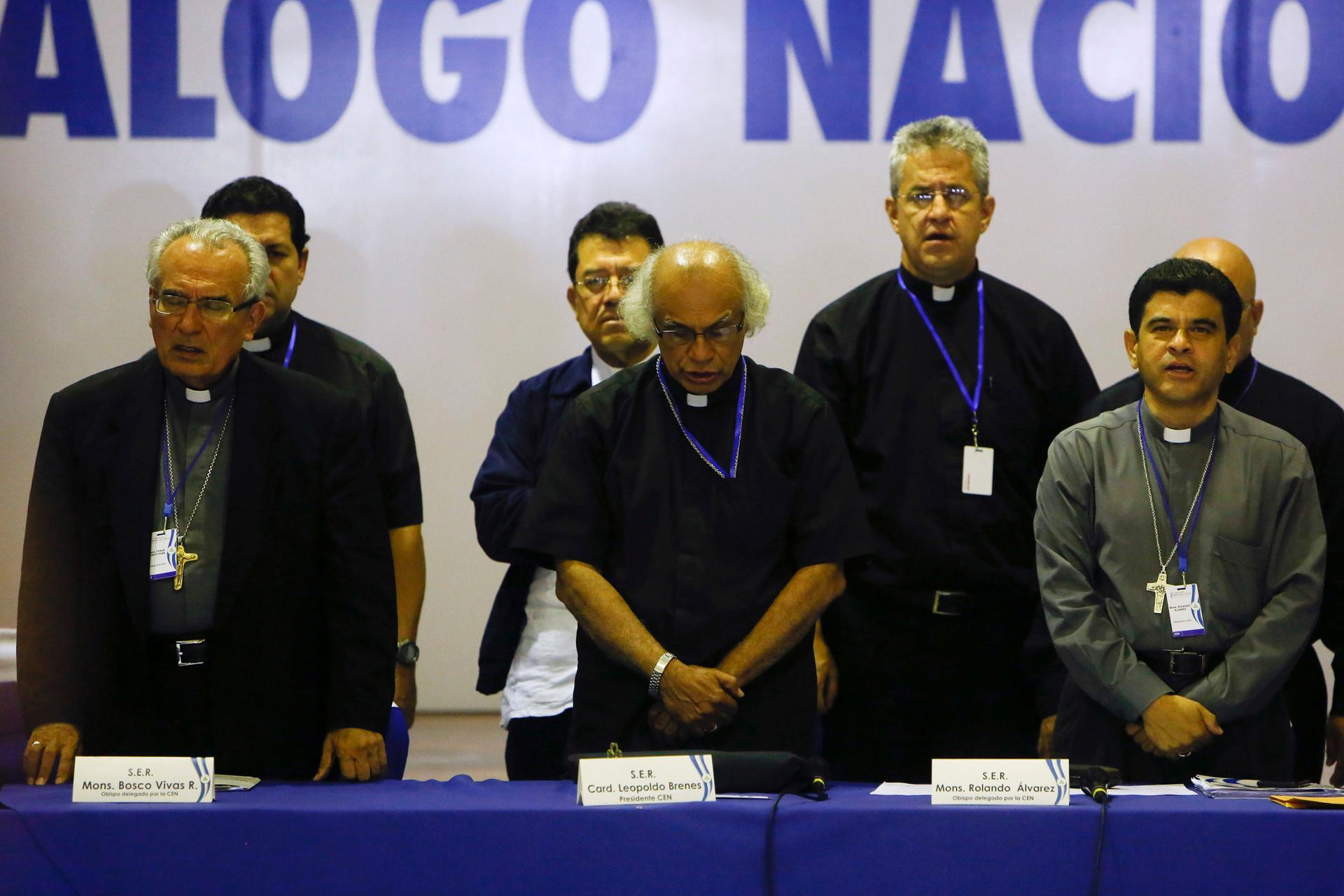 Bishop Cesar Bosco Vivas Robelo, left, Cardinal Leopoldo Brenes, center, and Bishop Rolando Alvarez, pray at the end of the third day of the national dialogue in Managua, Nicaragua, May 21, 2018.