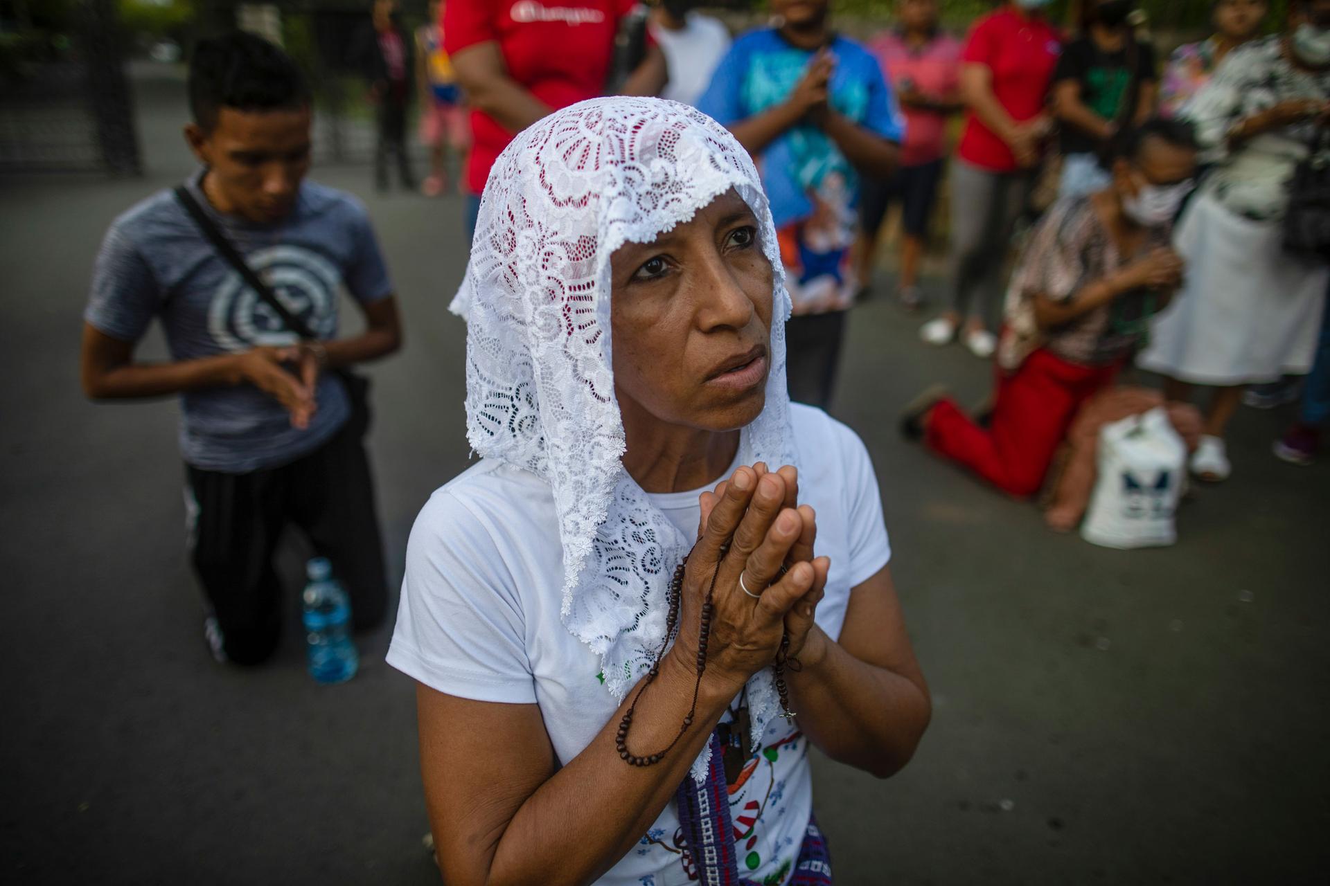A woman takes part in a reenactment of the Stations of the Cross during the Lenten season at the Metropolitan Cathedral in Managua, Nicaragua, Friday, March 17, 2023.