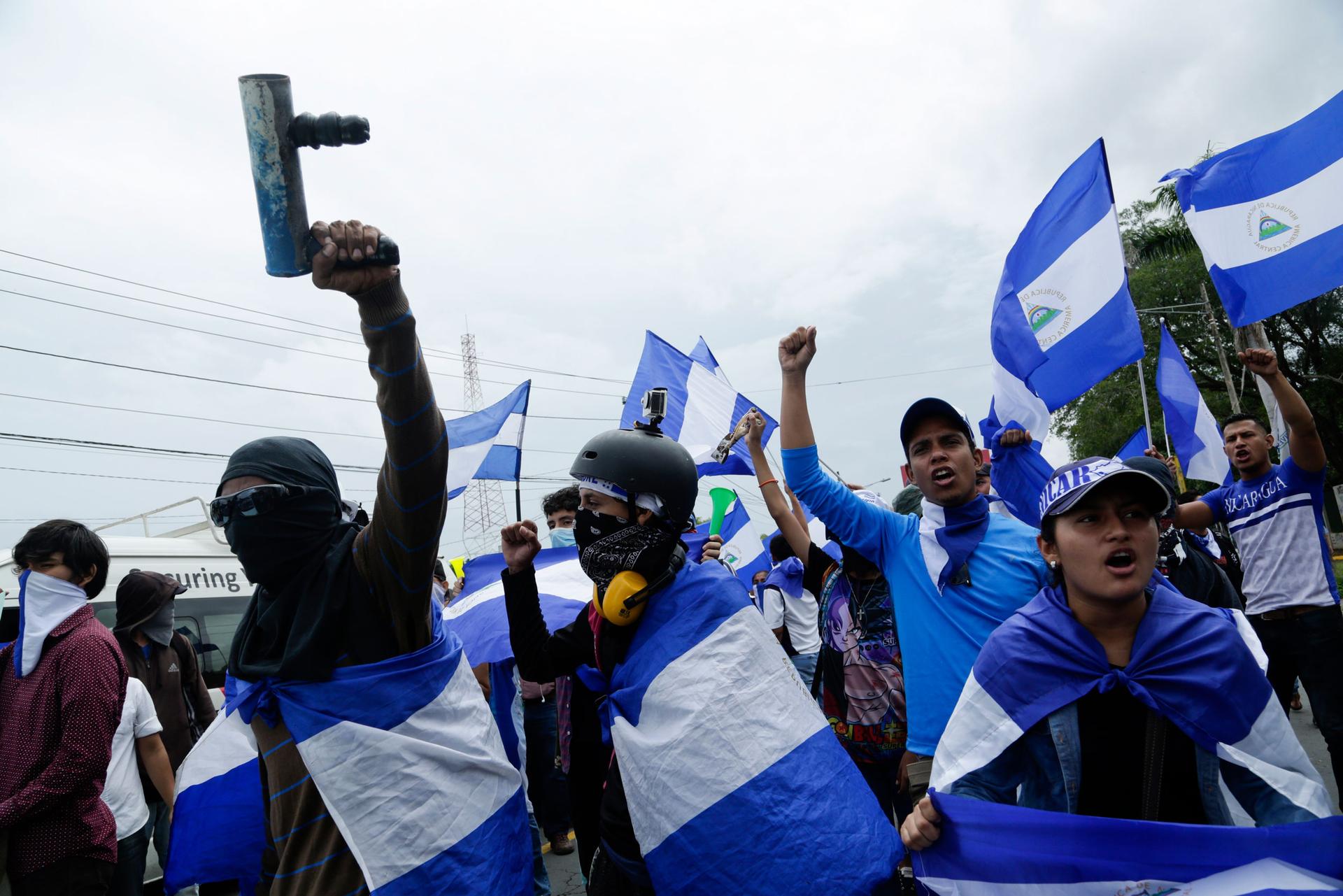 Demonstrators protest outside the Jesuit run Universidad Centroamericana, UCA, demanding the university's allocation of its share of 6% of the national budget, in Managua, Nicaragua, Thursday, Aug. 2, 2018.